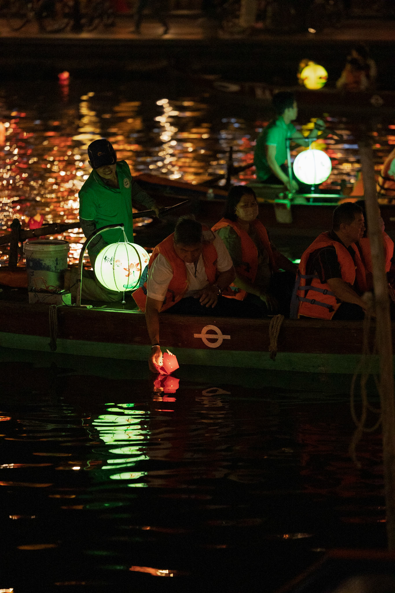 Lanterns float on the water, carrying wishes into the night