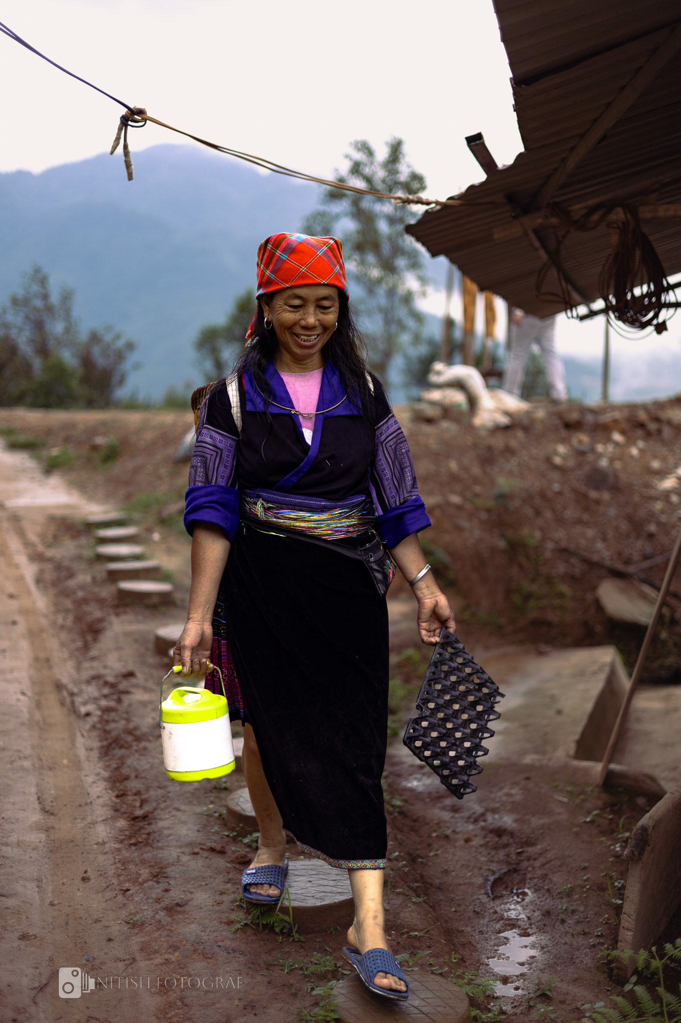 Carrying the essence of village life – a timeless stride through muddy paths