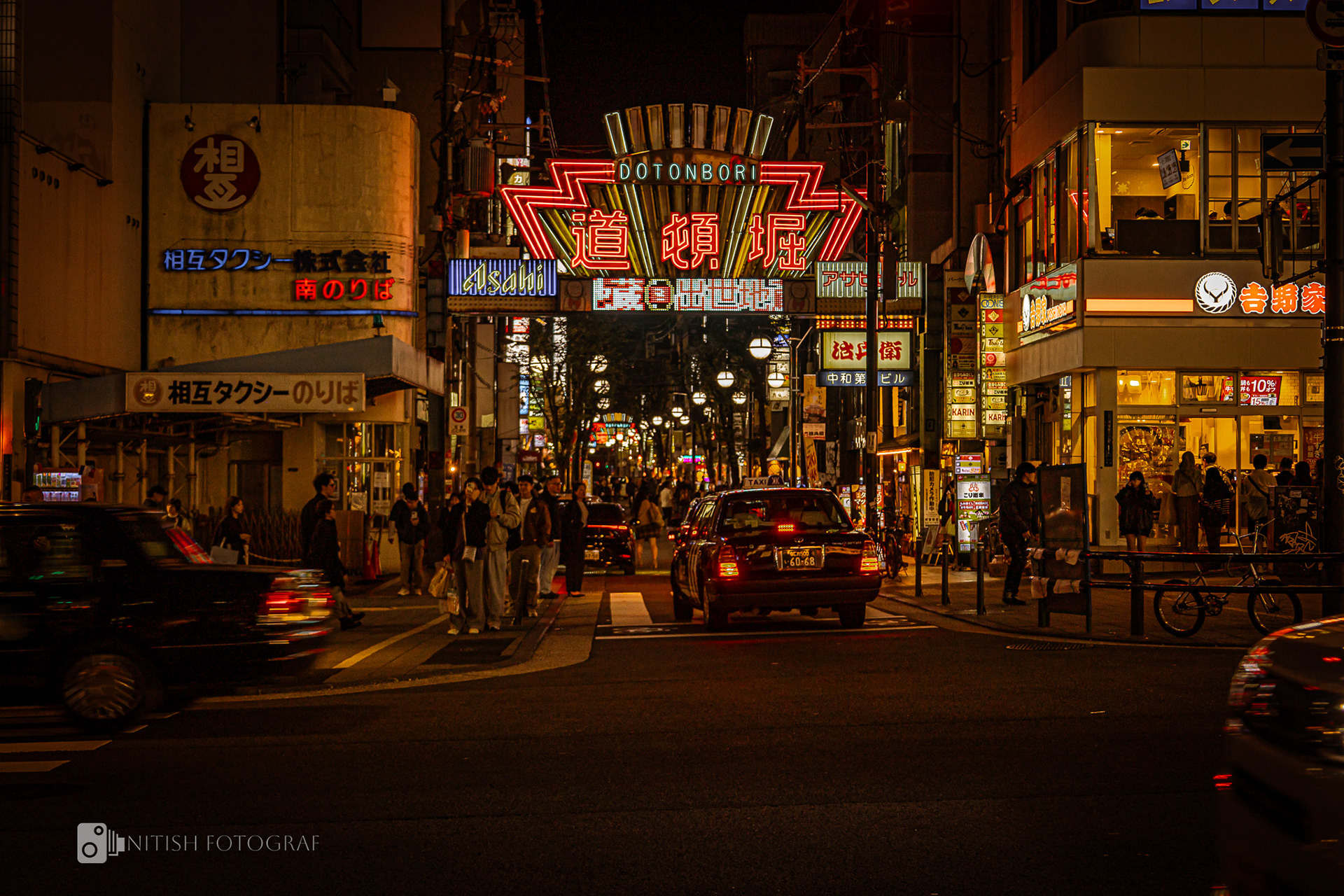 A bustling urban street alive with neon lights and local charm
