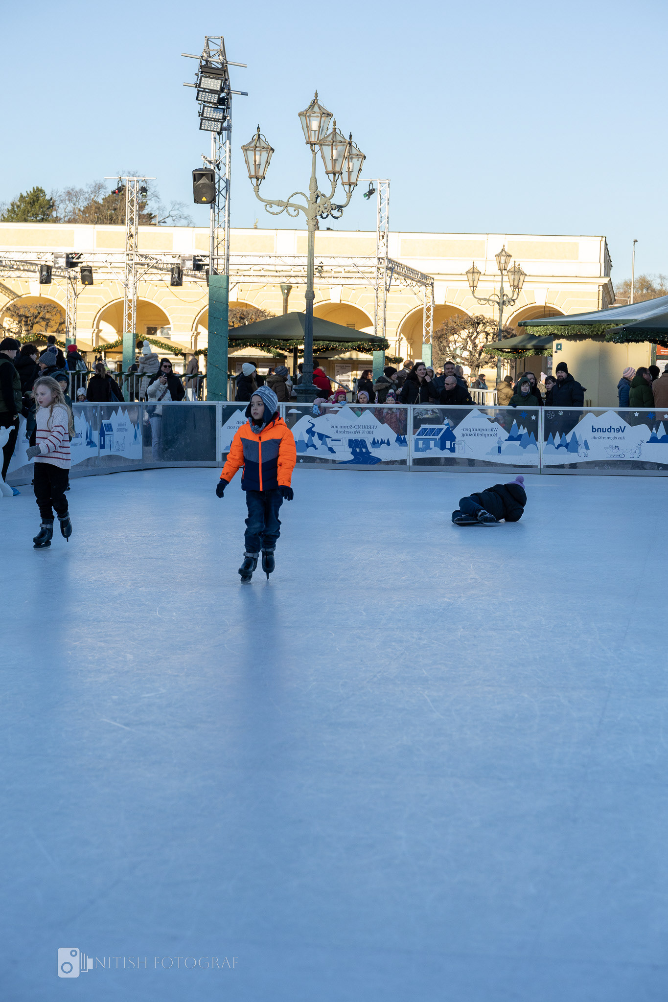 An ice rink alive with movement, joy, and the crisp magic of the season