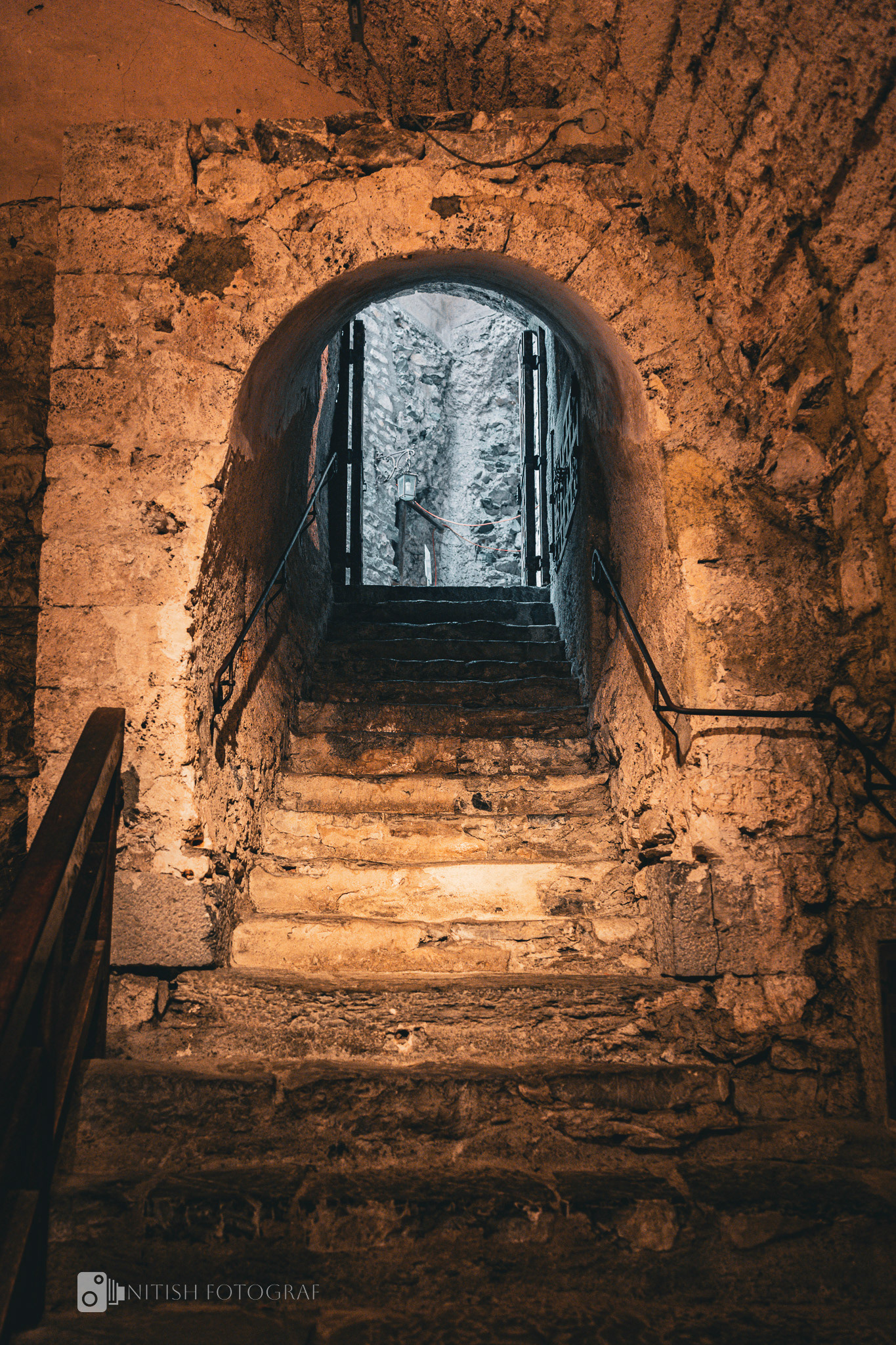 A stone archway leading into the echoes of history