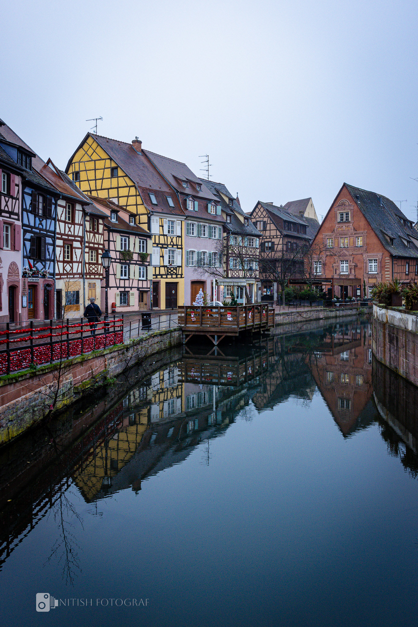 Colorful facades mirrored on calm waters—a perfect harmony of nature and architecture