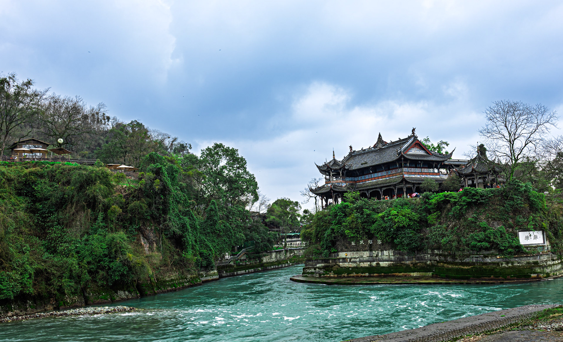 A tranquil river winds through ancient architecture, where history and nature meet