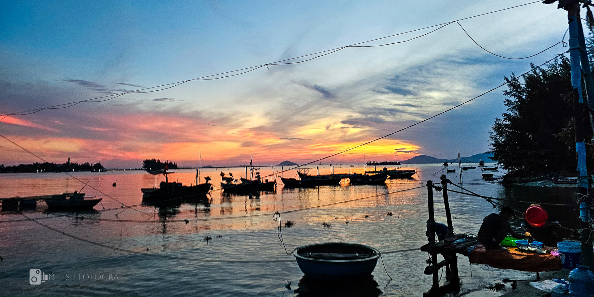 A fiery sunrise to the day over a calm sea
