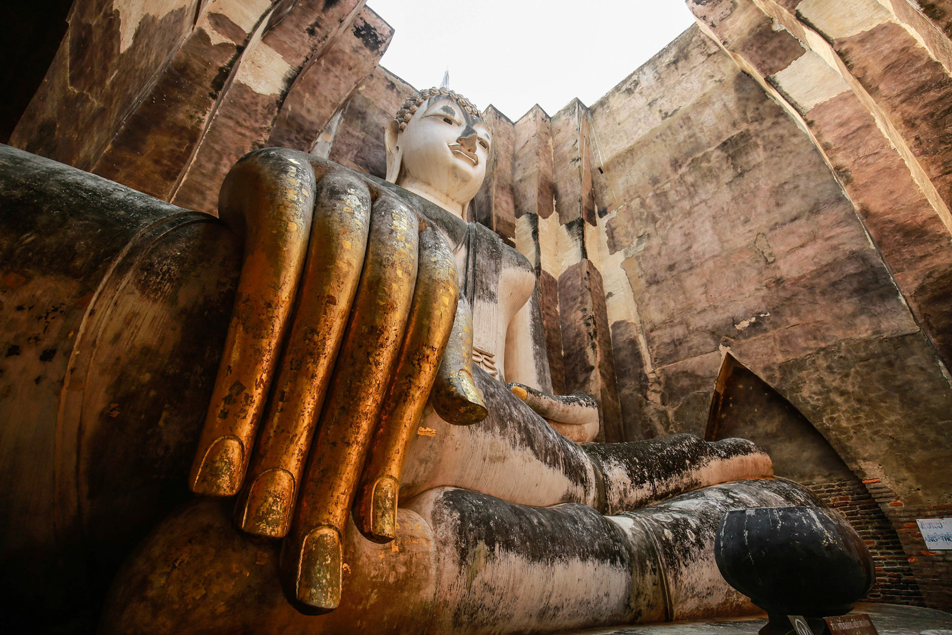 Wide angle shot of the famous buddha statue, Phra Achana at Wat Sri Chum temple at Sukhothai Historical park, Sukhothai, Thailand.