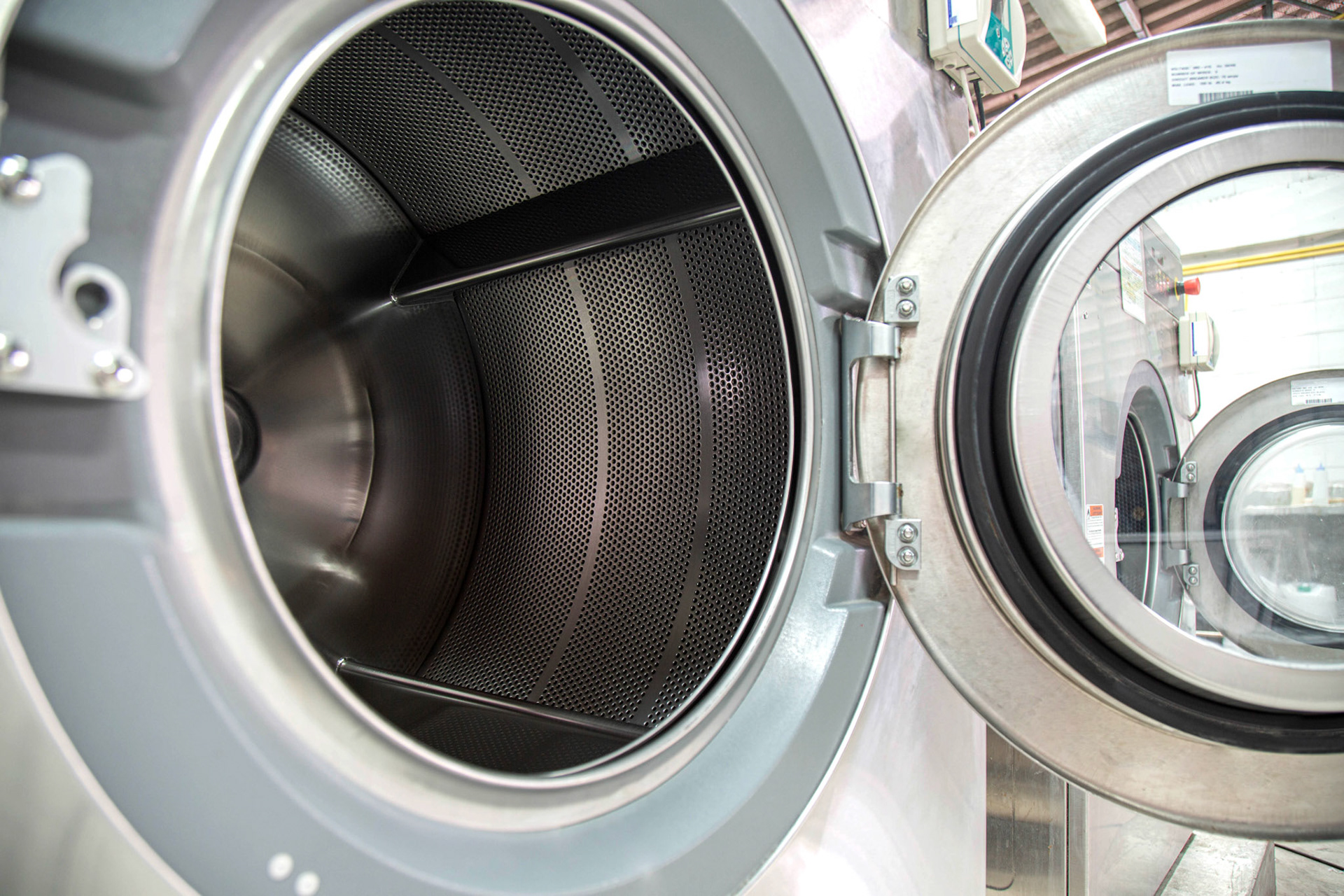 Big wide opening front doors of industrial washing machines. Shot taken in the factory.