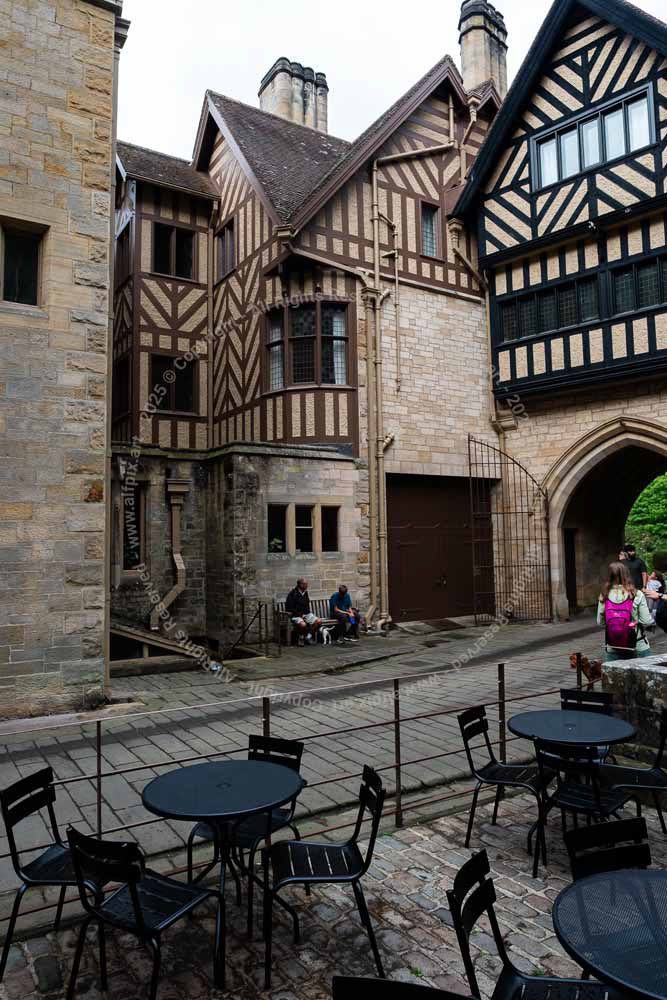 Inside archway entrance to Cragside house. Modern visitor cafe.