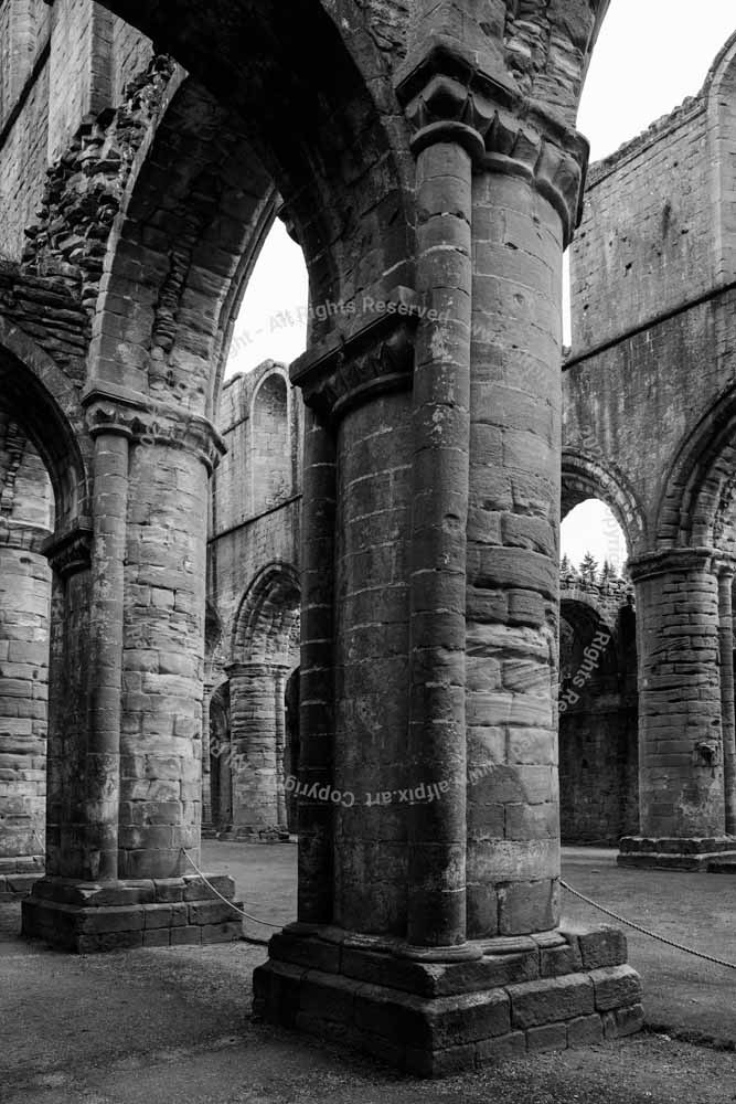 Mighty stone columns. Fountains Abbey. Black and White image.