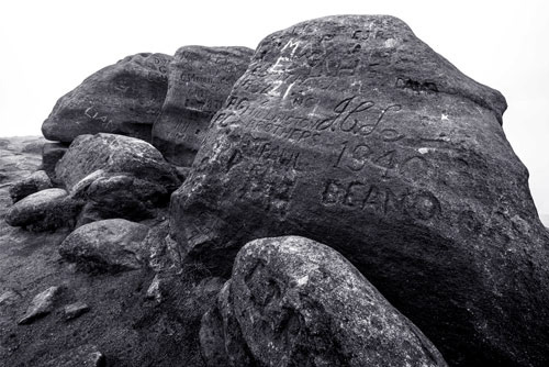 Inscribed grafitti on rocks, higher shelf stones near Bleaklow. Monochrome image. alffpix.art chris chapman