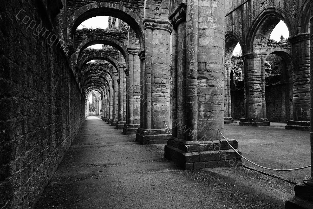 View along the side of the Nave. Fountains Abbey. Black and White image.