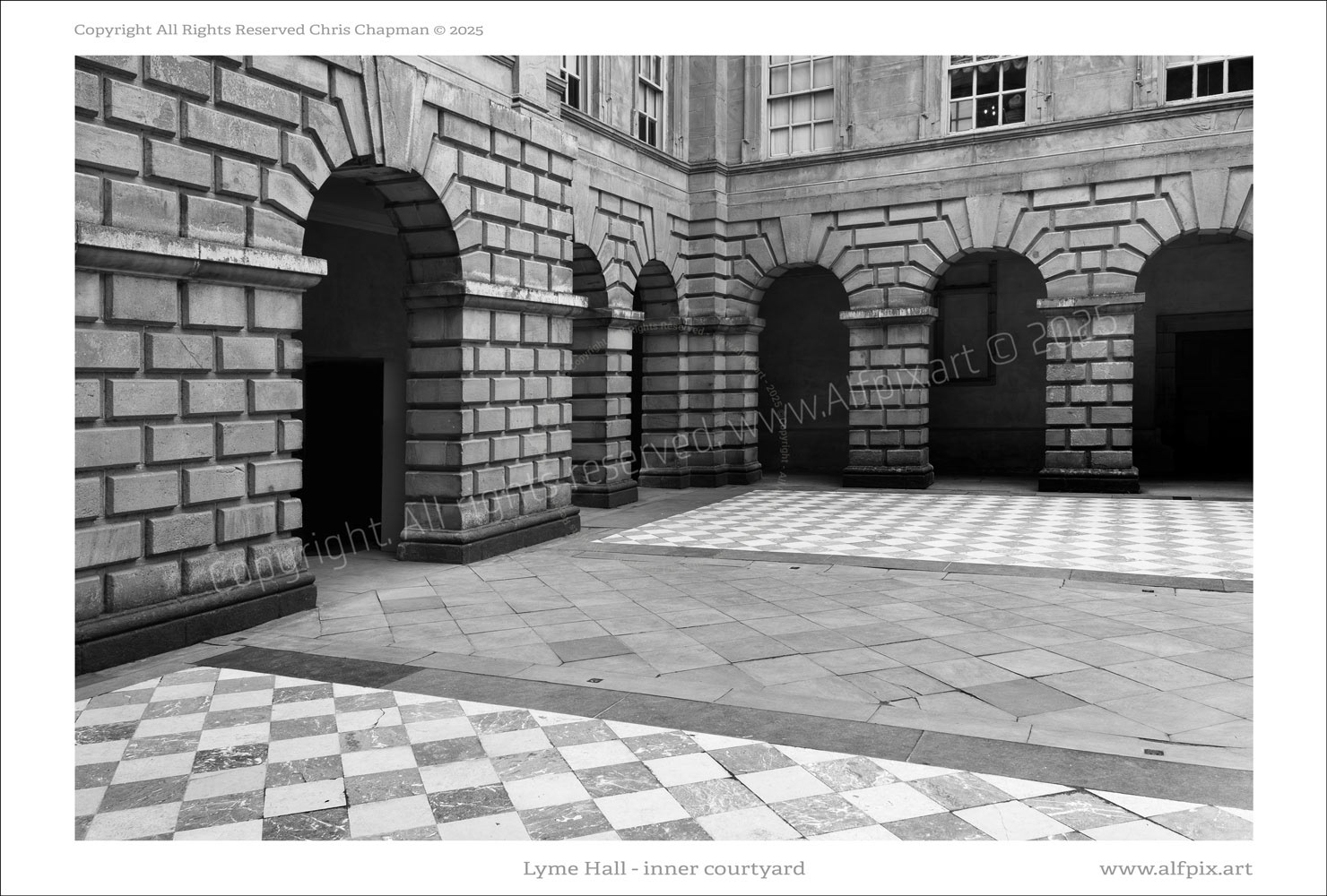The inner courtyard of Lyme Hall. Black and White image. Chequered tiled flooring. Magnificently dressed stonework. 