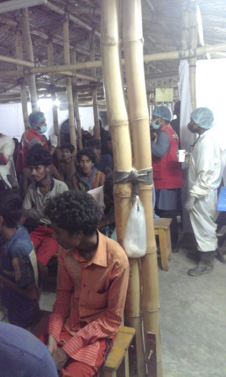 Boat survivors being screened (Withheld)