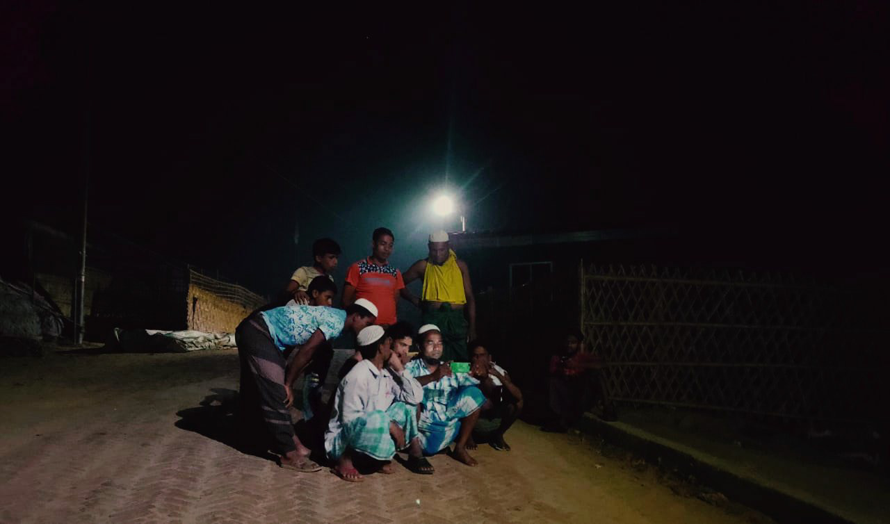 Md. Yassin - people huddled together at a signal spot to read news