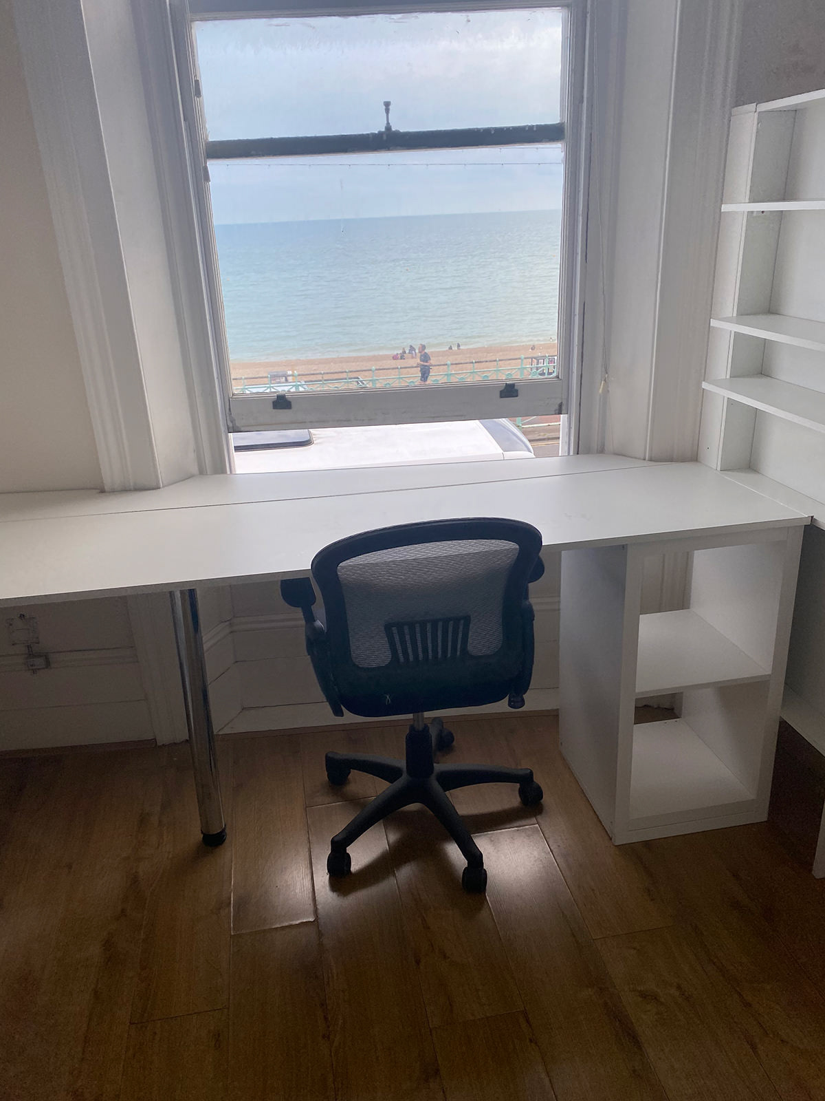 Large desk, whiteboard, book shelves, sea view
