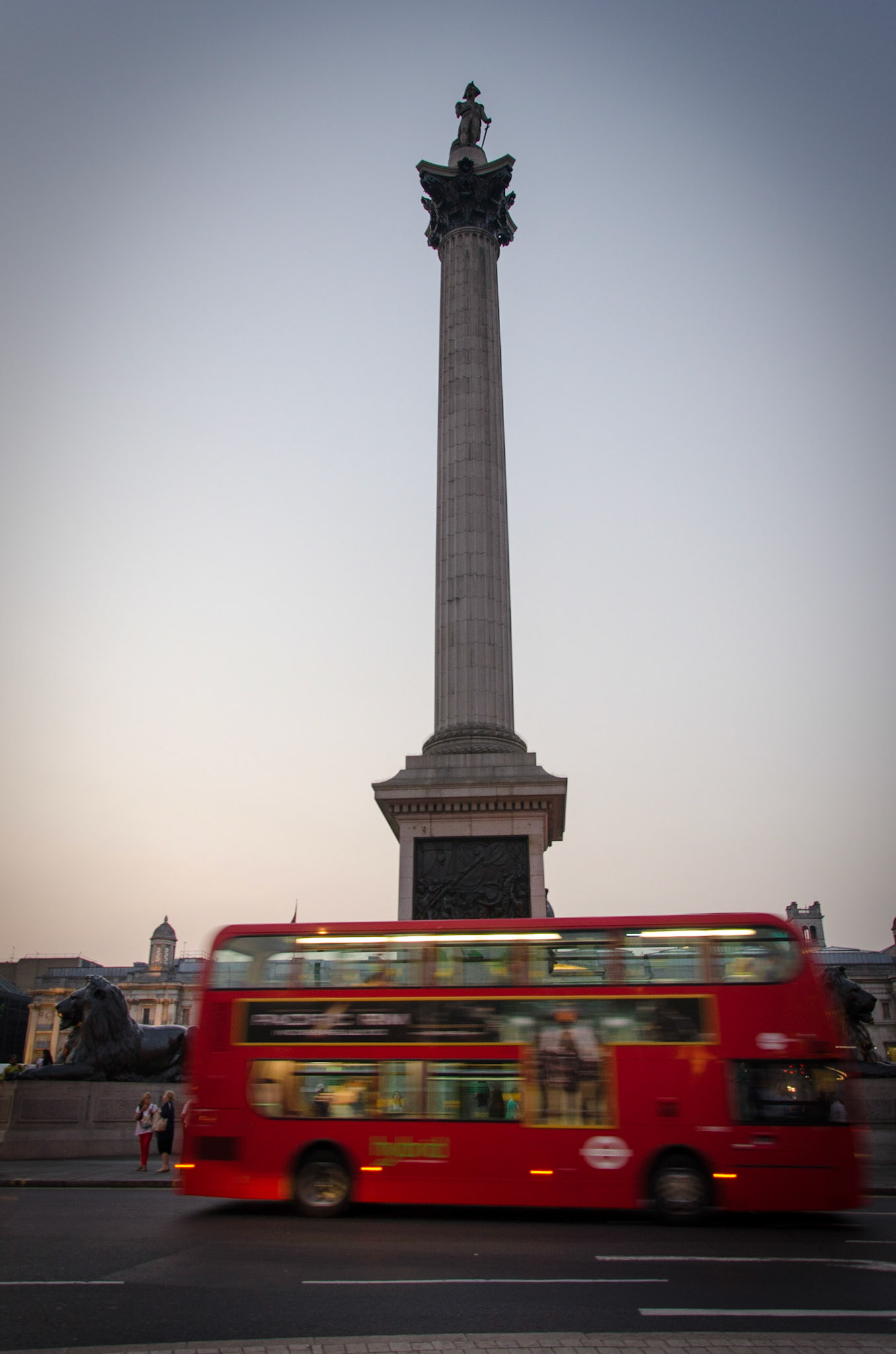 A double-decker bus going past Nelson's Column in London