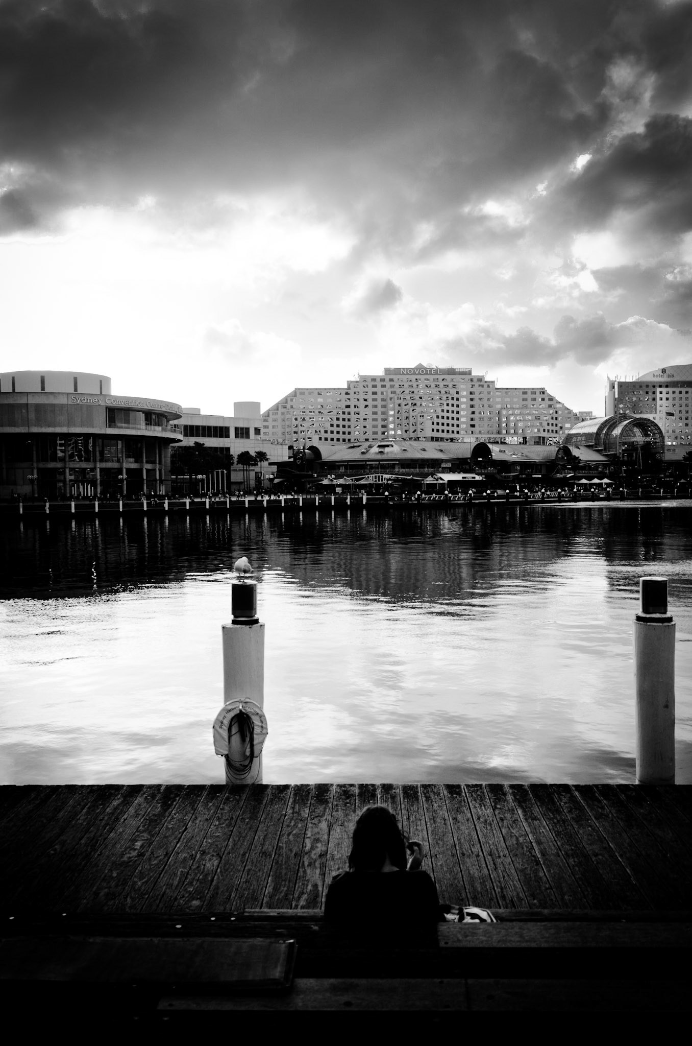 A girl watching the sunset in Sydney Darling Harbour