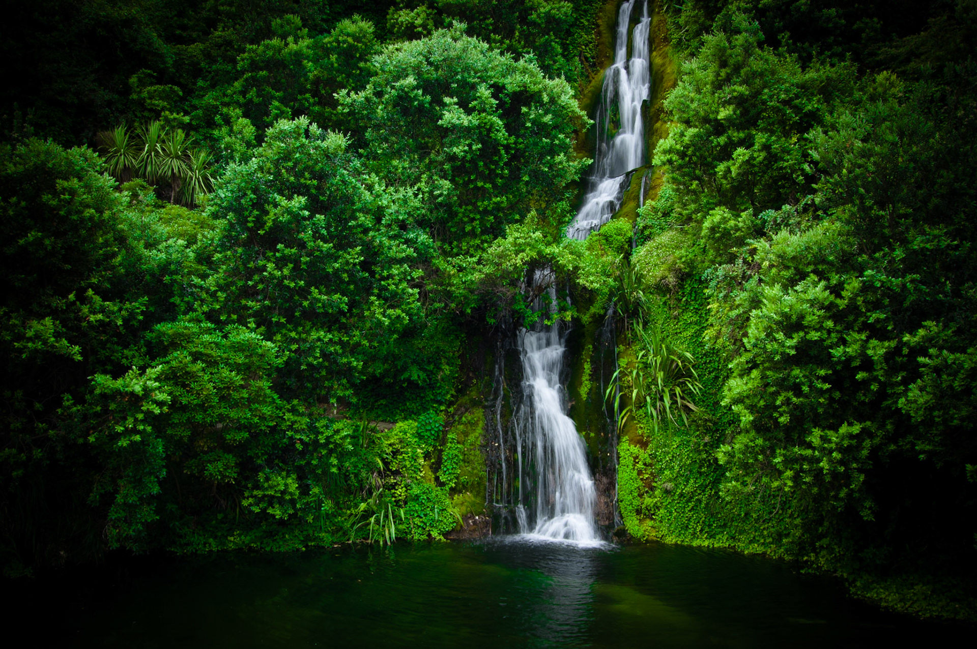 A waterfall cascading down into a pool in the Centennial Gardens in Napier