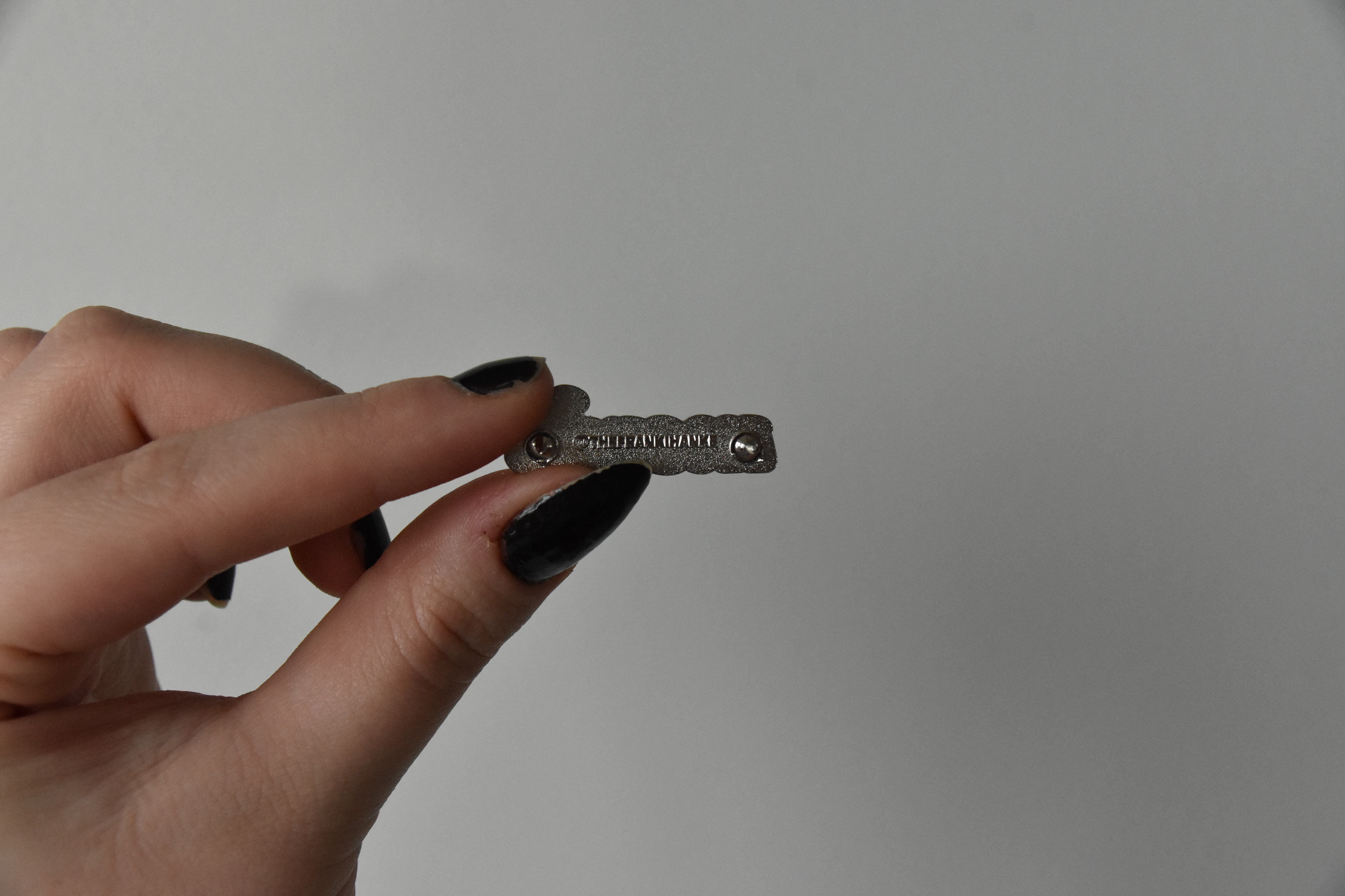 The metal backstamp provides branding to the pins themselves.