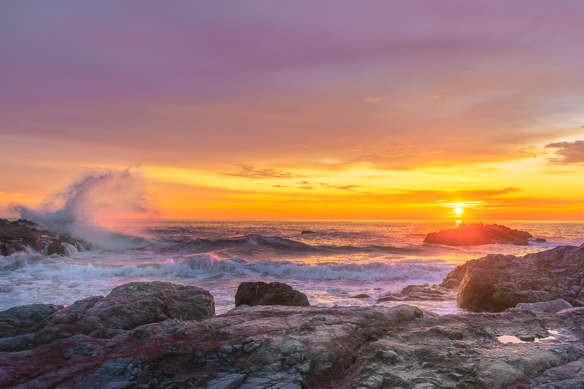 Wave splashing on rocks during sunset Yachats Oregon Coast