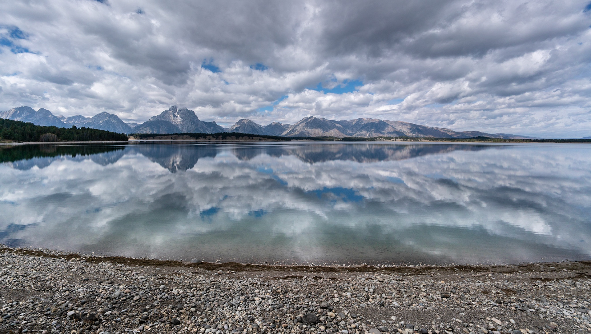Looking at a still water reflection of the Grand teons National Park in Wyoming was wonderful