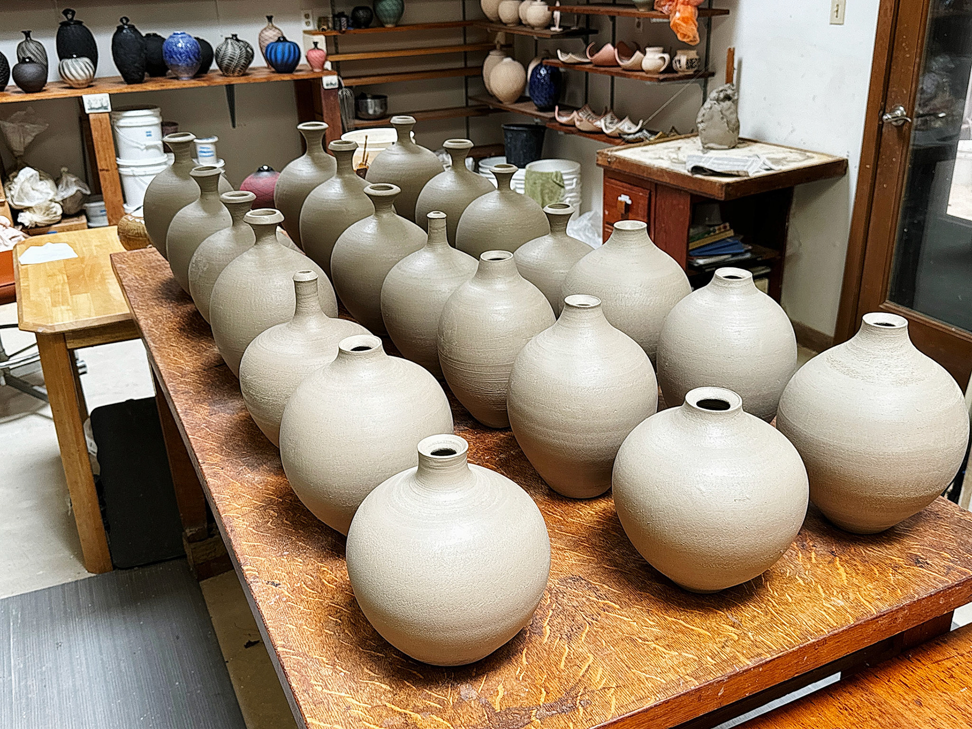 Finished vases drying for bisque firing.
