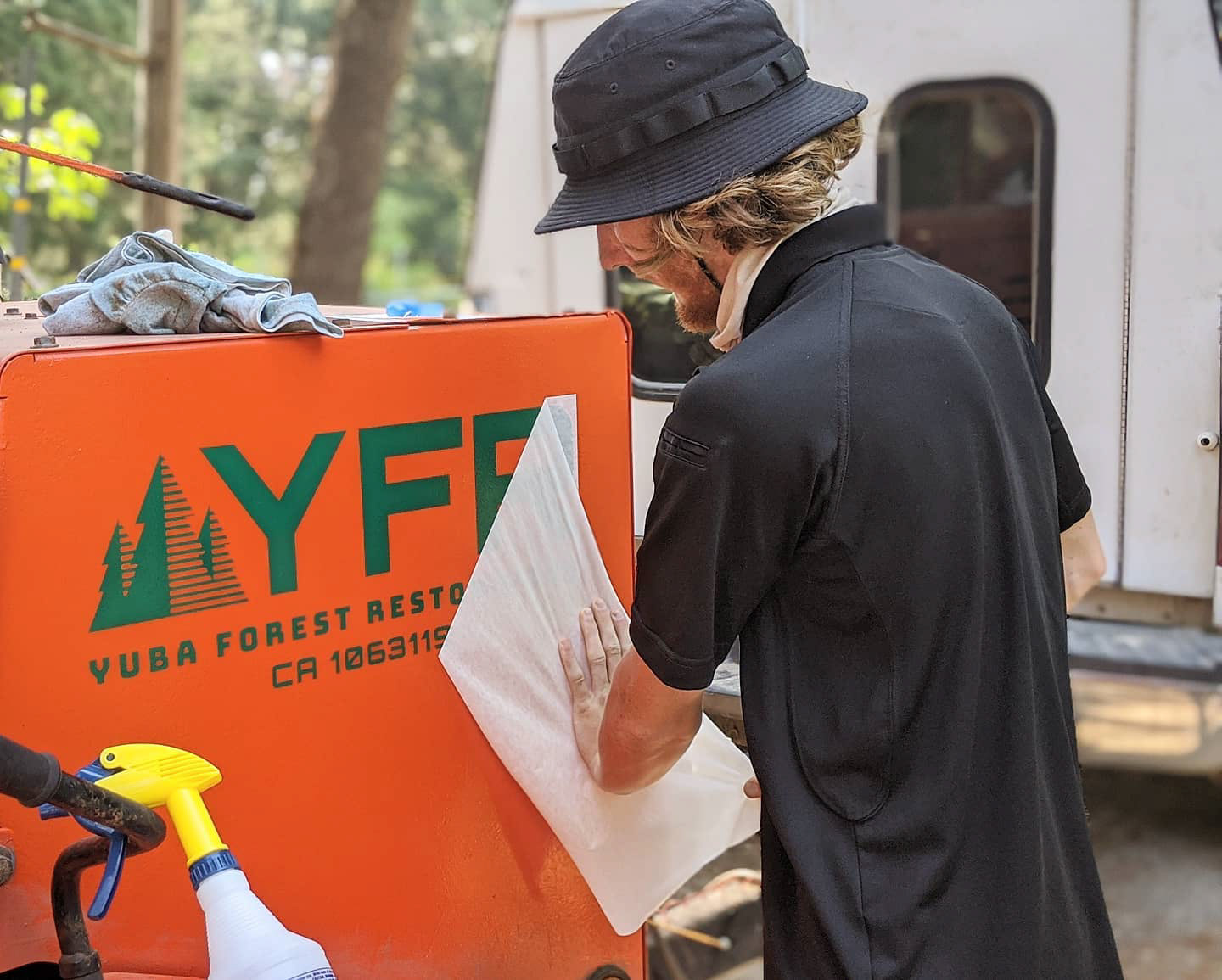 YFR logo being applied on wood chipper (vinyl work done by Slaps! Enterprise)