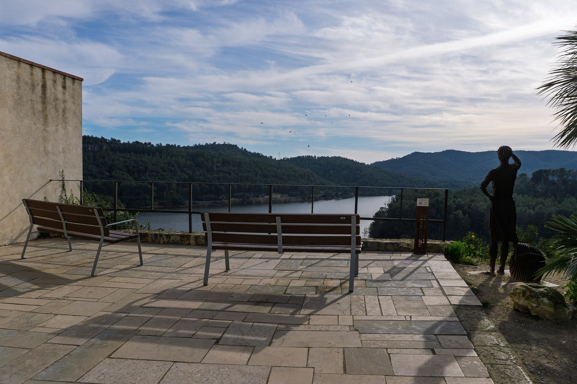 A viewpoint over the reservoir, guarded by a woman's sculpture.