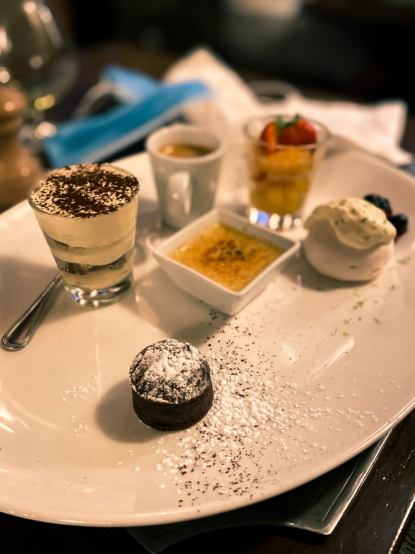 A selection of different deserts before a cup of coffee.