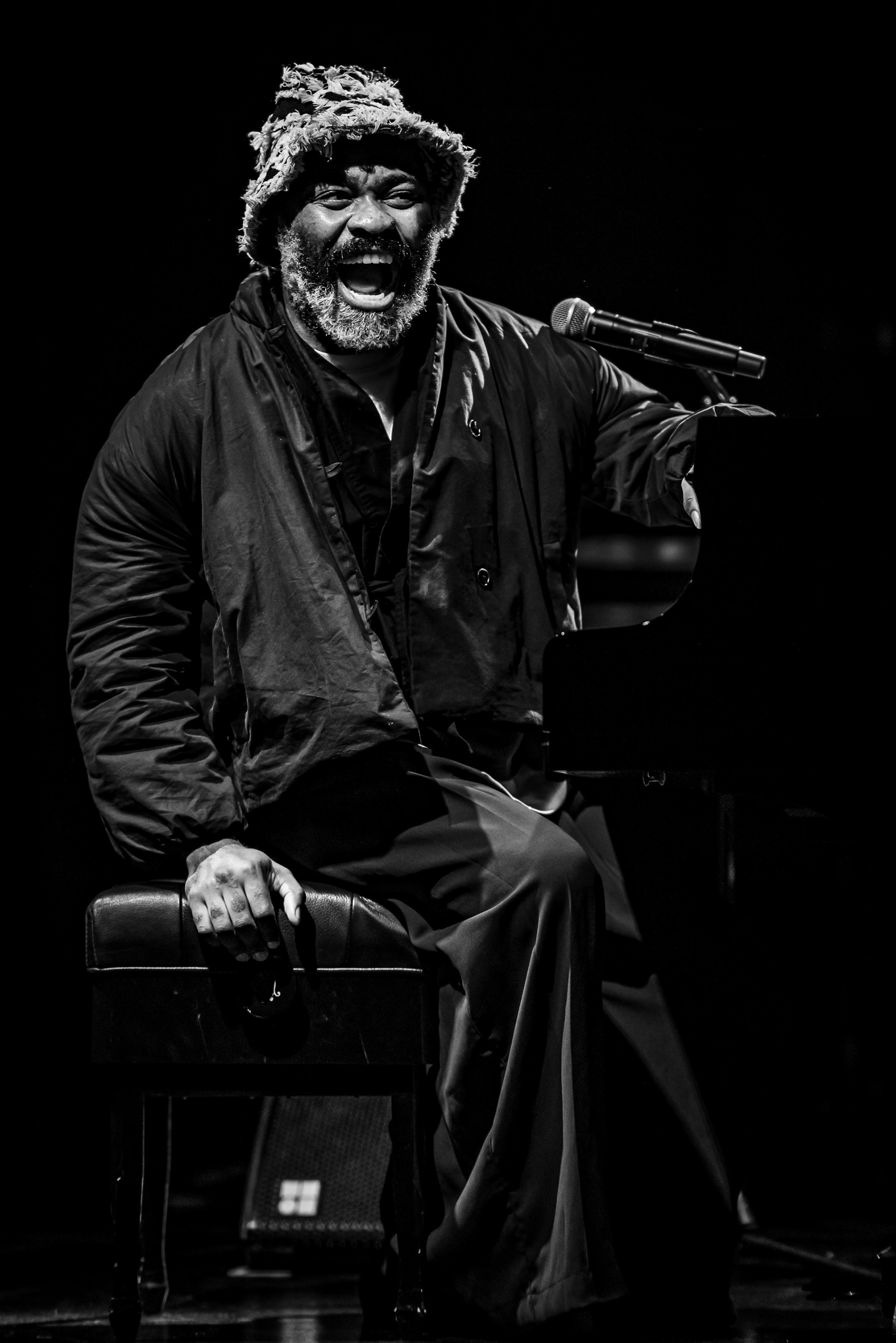Emotional expression of a jazz pianist Nduduzo Makhathini on stage, raw black and white concert portrait, Kalisz Jazz Festival, photo by Szymon Ratajczyk.