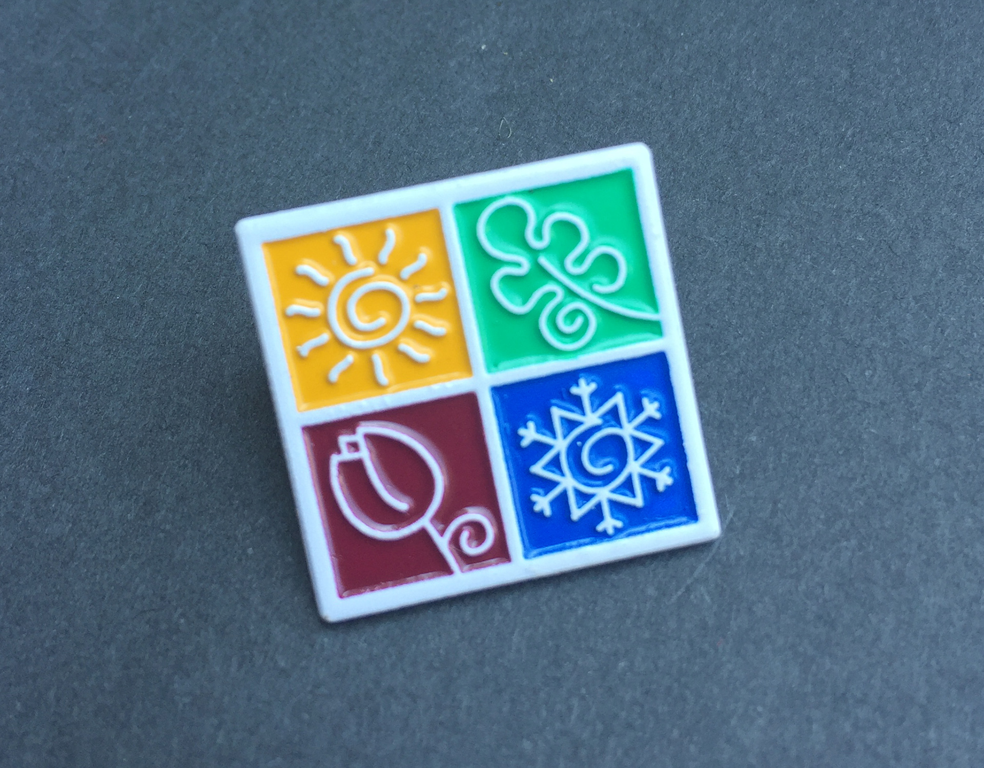 White Enamel Dipped Lapel Pin Process that I created for a consumer looking for a unique solution.  This process became a standard offering.