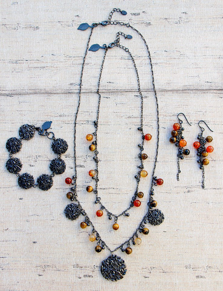 Necklace, bracelet and earring set I designed.  The 3D Cast metal charms were designed and manufactured for this set, and created all of the technical specifications for manufacturing.