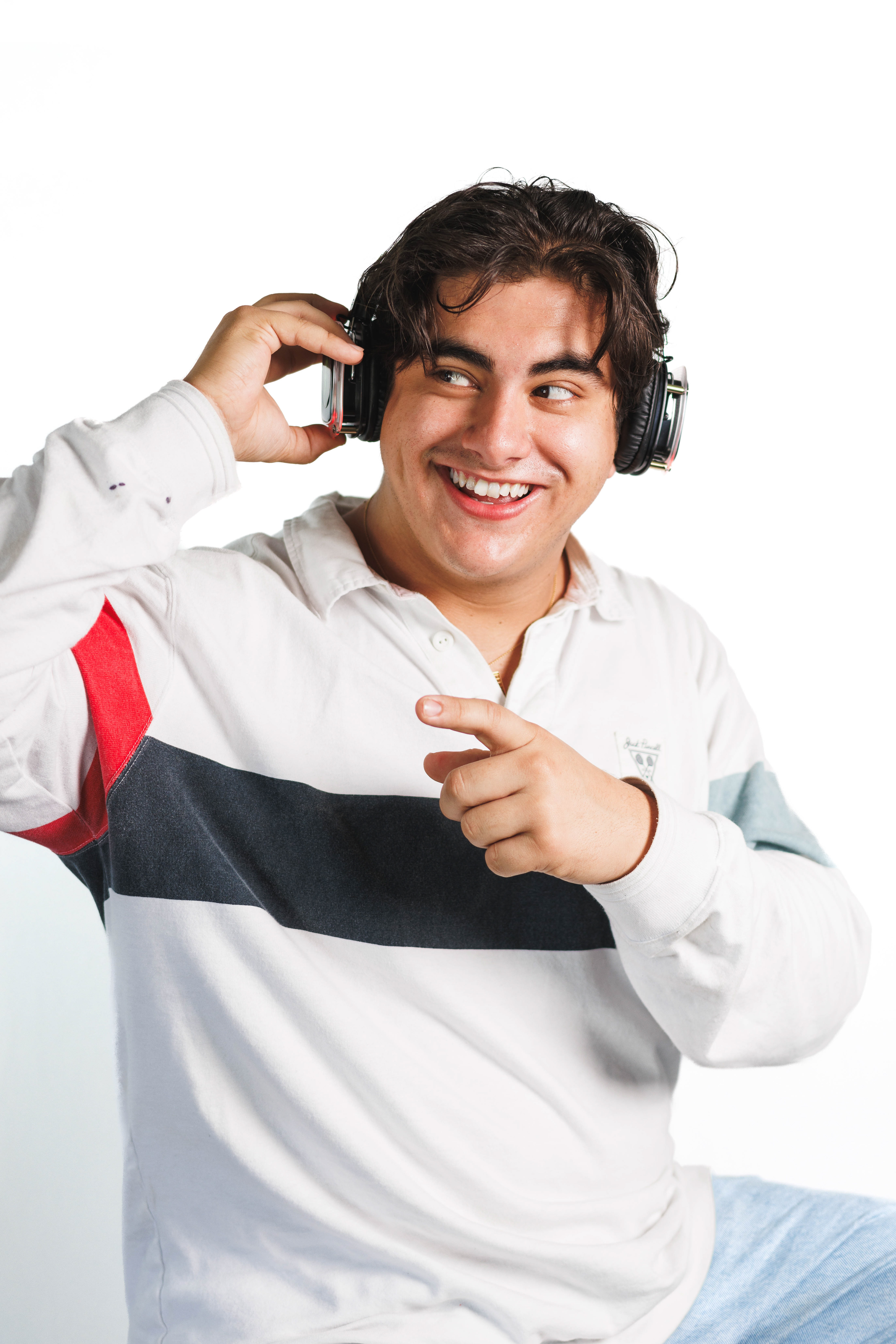 @shutupanddance.llc | Silent disco headphones photoshoot with white backdrop while pointing off-screen.