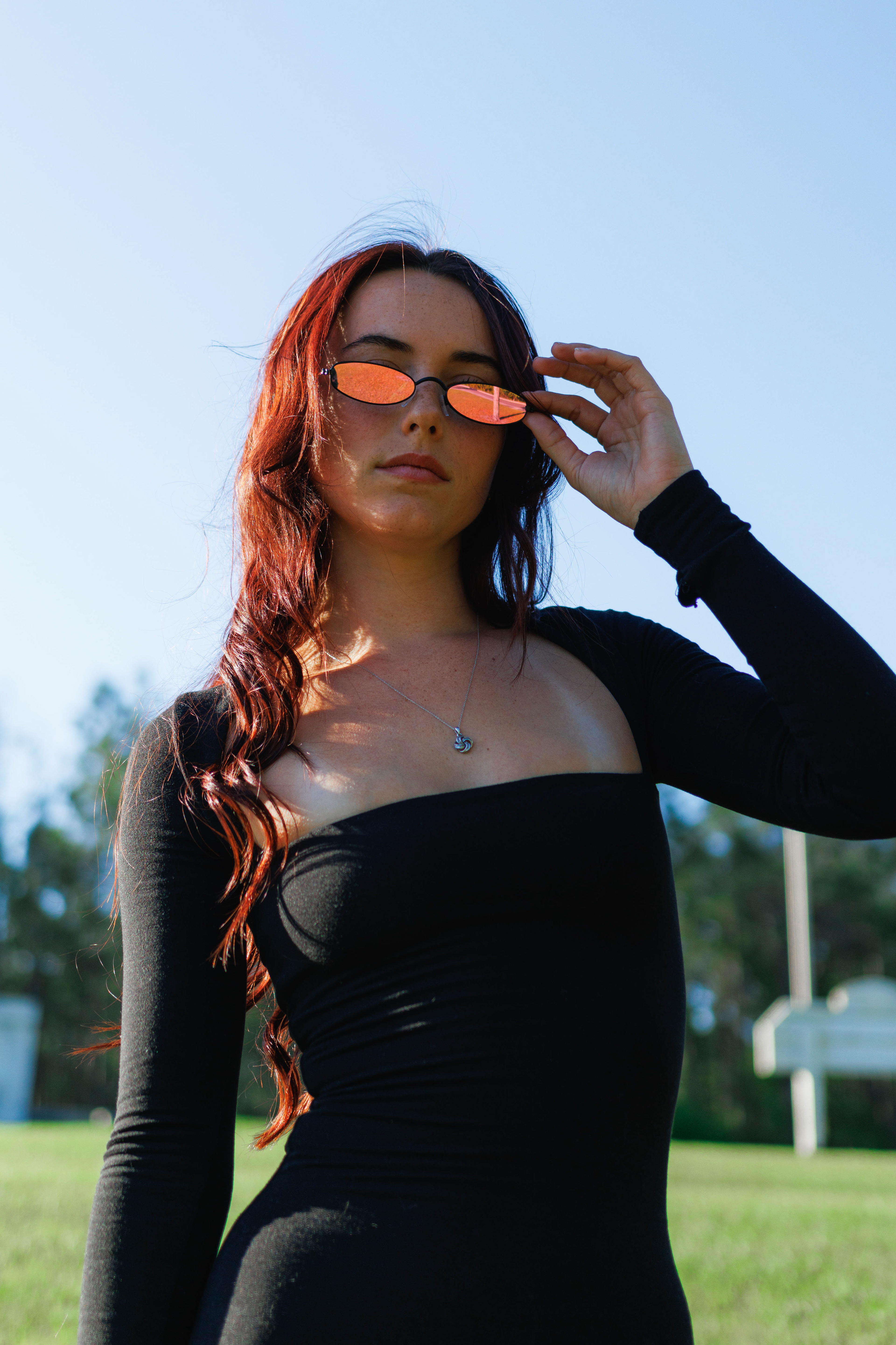 Meghan | Outdoor sunny fashion photoshoot with y2k vintage sunglasses, bodysuit, white purse mid-shot