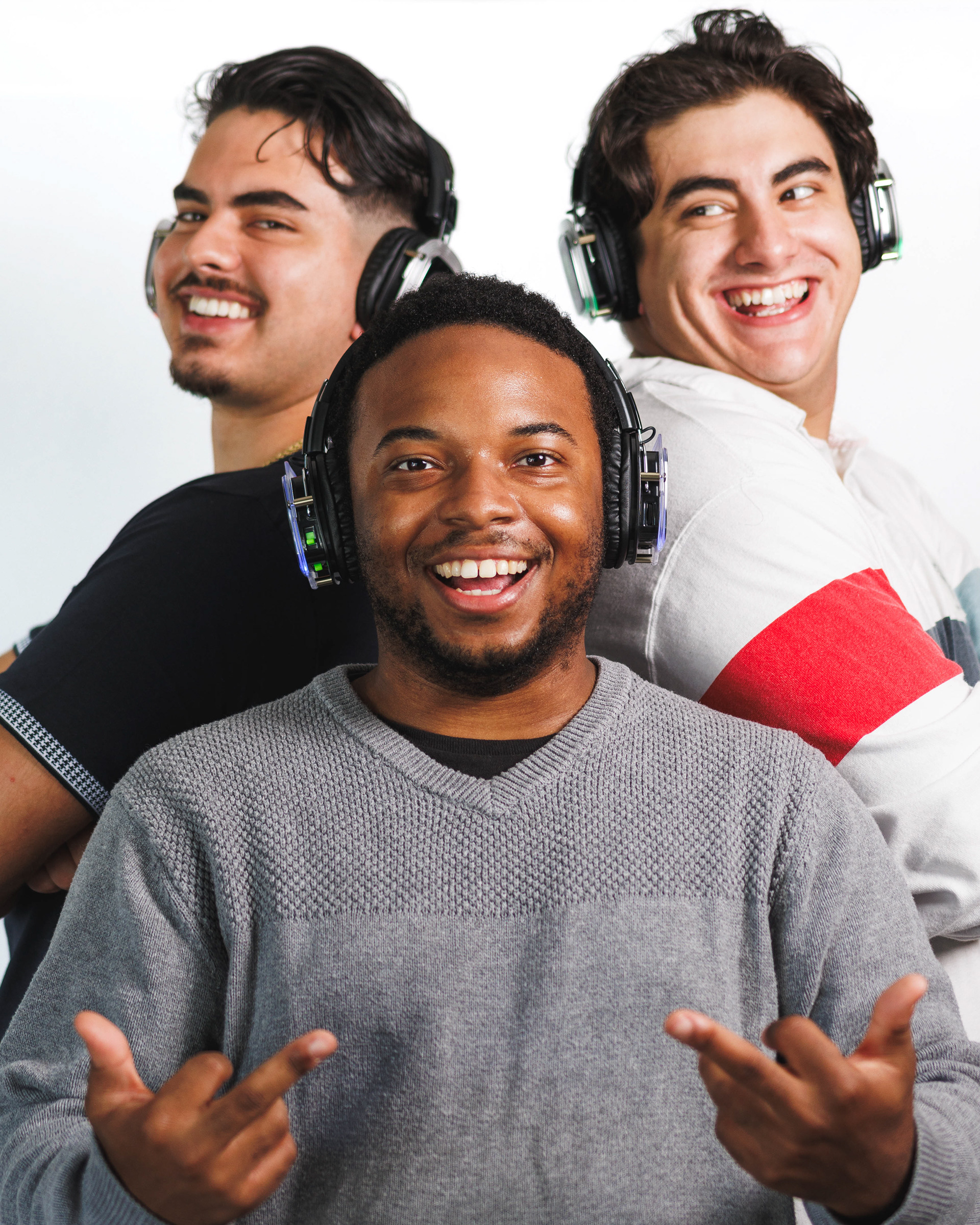 @shutupanddance.llc | Silent disco headphones photoshoot with white backdrop and three friends laughing