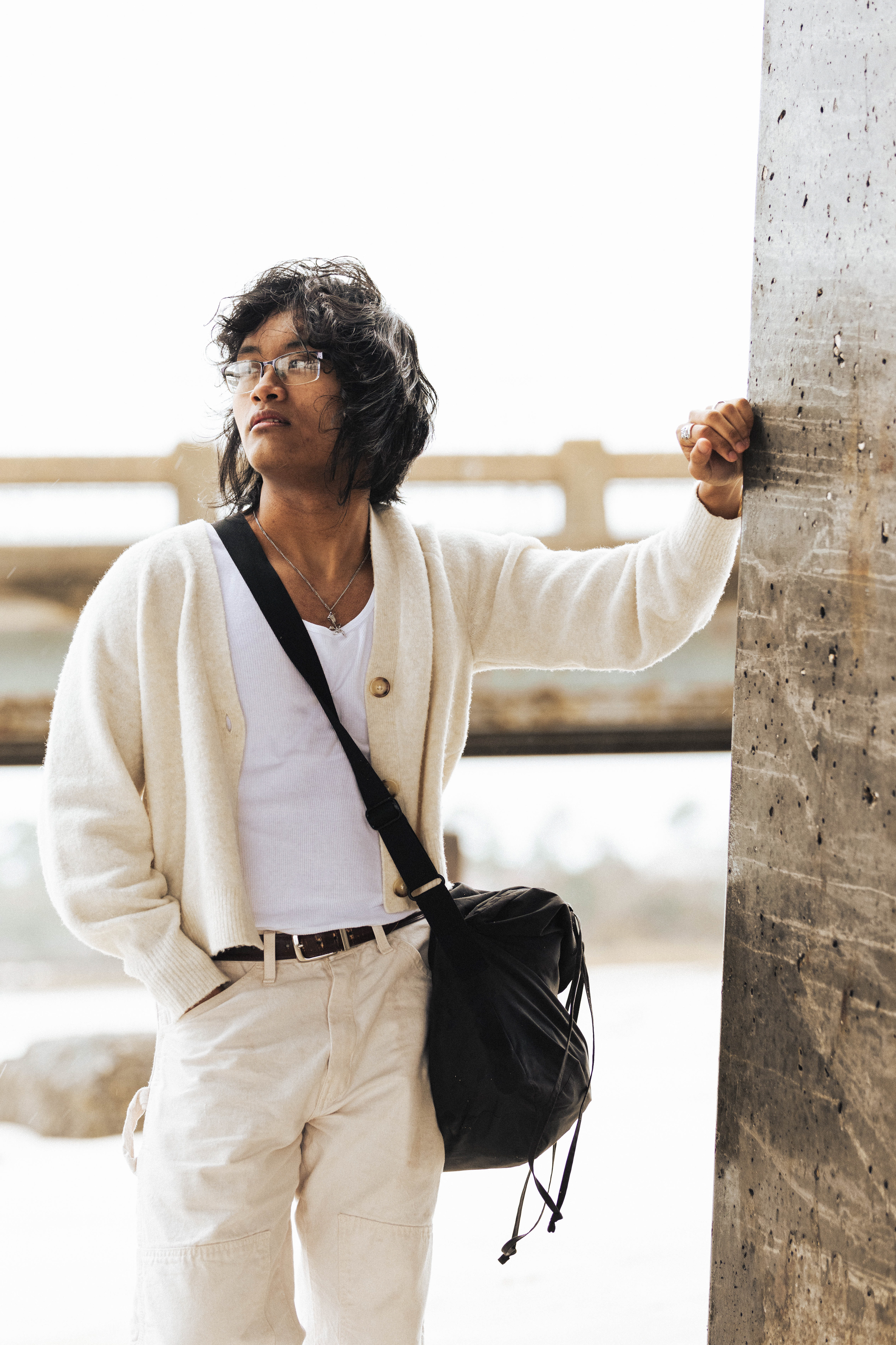 @itsme.devinc | Moody outdoor cloudy photoshoot with cream-colored cartigan and dickies. Men's fashion photoshoot
