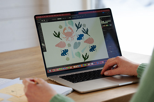 Swedish artist and surface pattern designer ann-katrin persson working on a pattern on her computer