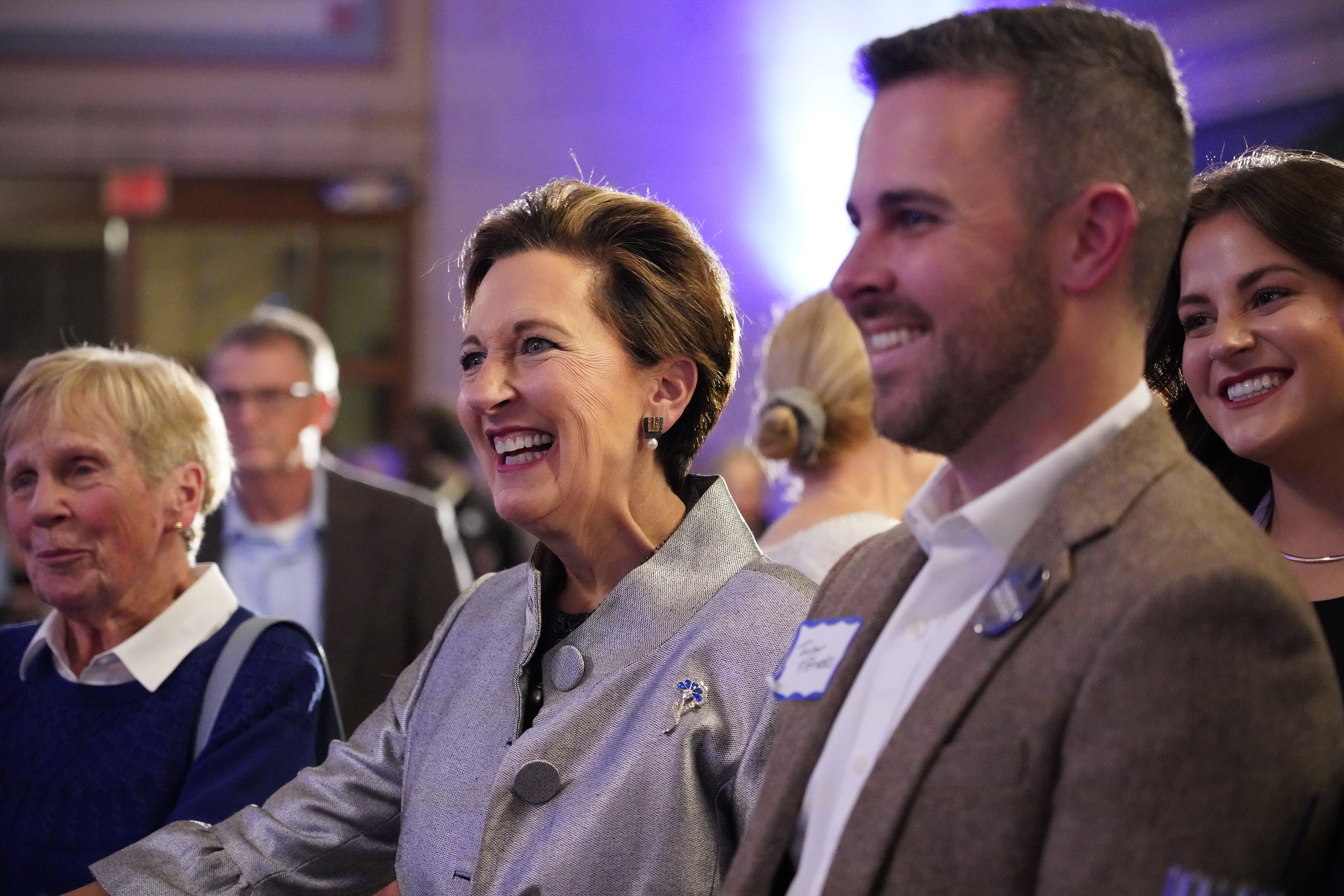 Patty Pansing Brooks smiles while talking to supporters during her election night party at Lincoln Station Great Hall on Nov. 8, 2022. Two of her three children, Taylor Brooks and Avary Pansing Brooks, are pictured to the right. (Nebraska News Service / Naomi Delkamiller)