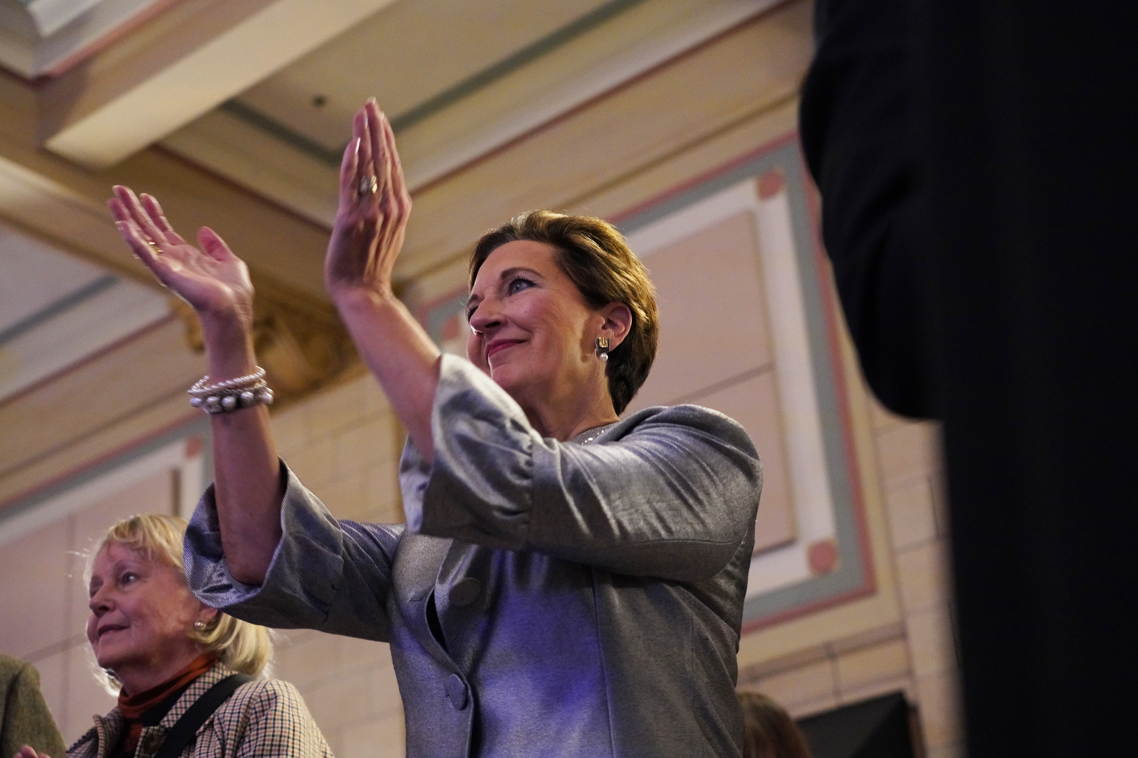 Patty Pansing Brooks claps as musical guests take the stage during her election night party at Lincoln Station Great Hall on Nov. 8, 2022. (Nebraska News Service / Naomi Delkamiller)