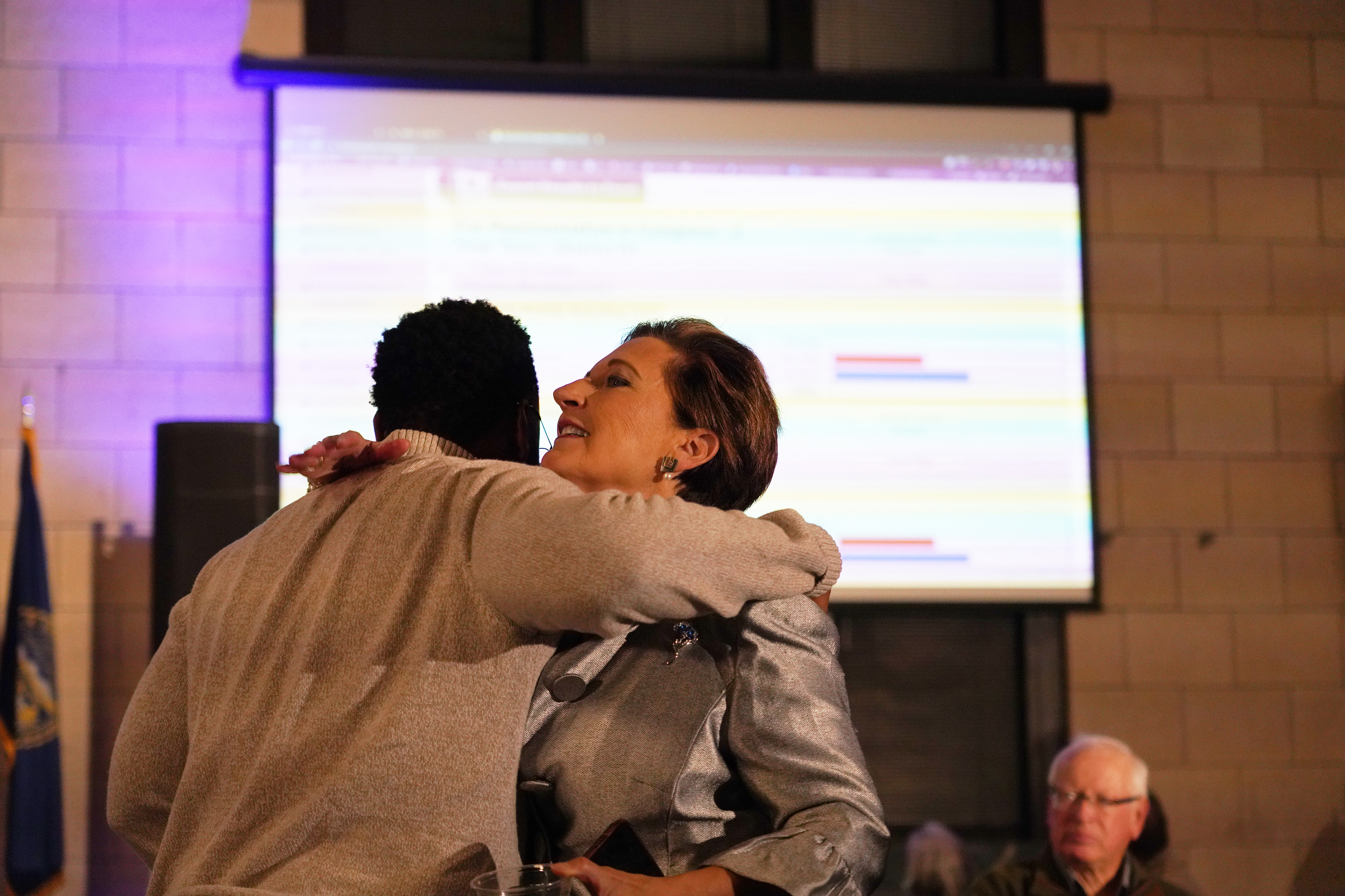Patty Pansing Brooks hugs a supporter as the first round of election results come in during her election night party at Lincoln Station Great Hall on Nov. 8, 2022. (Nebraska News Service / Naomi Delkamiller)