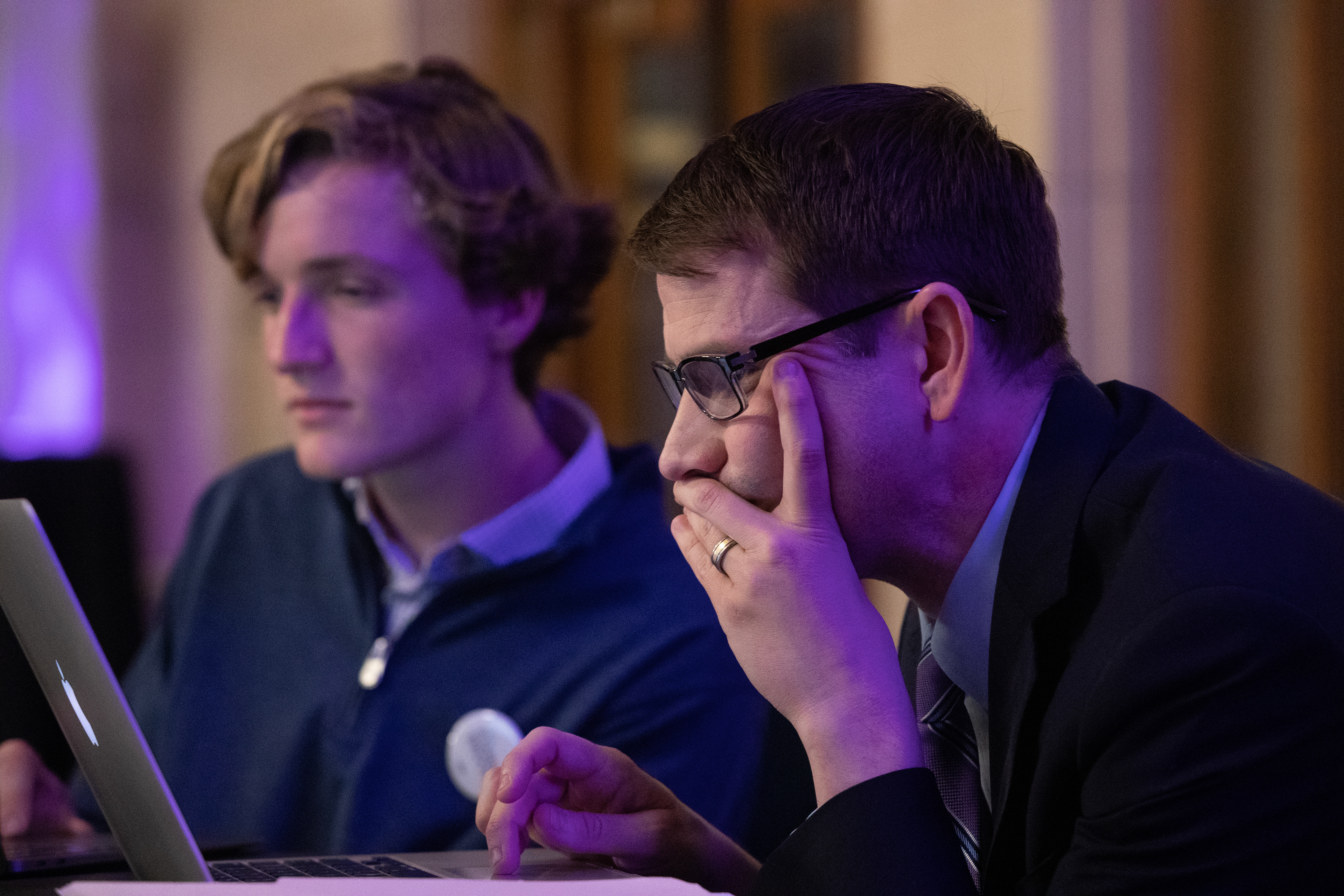 Campaign Director Chris Triebsch and his assistant Henry Cline react to election results moments before Patty Pansing Brooks delivers a concession speech to opponent Mike Flood in the race for the Nebraska district one congressional seat at Lincoln Station Great Hall on Nov. 8, 2022. (Nebraska News Service / Naomi Delkamiller)