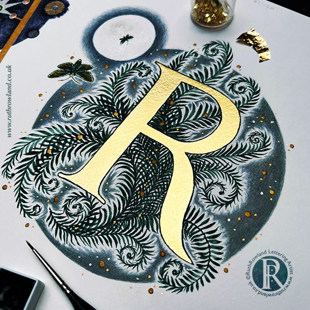 Lettering Artist UK London Ruth Rowland - Gilded Capital R with watercolour ferns - photo of worksheet with brush and gold leaf