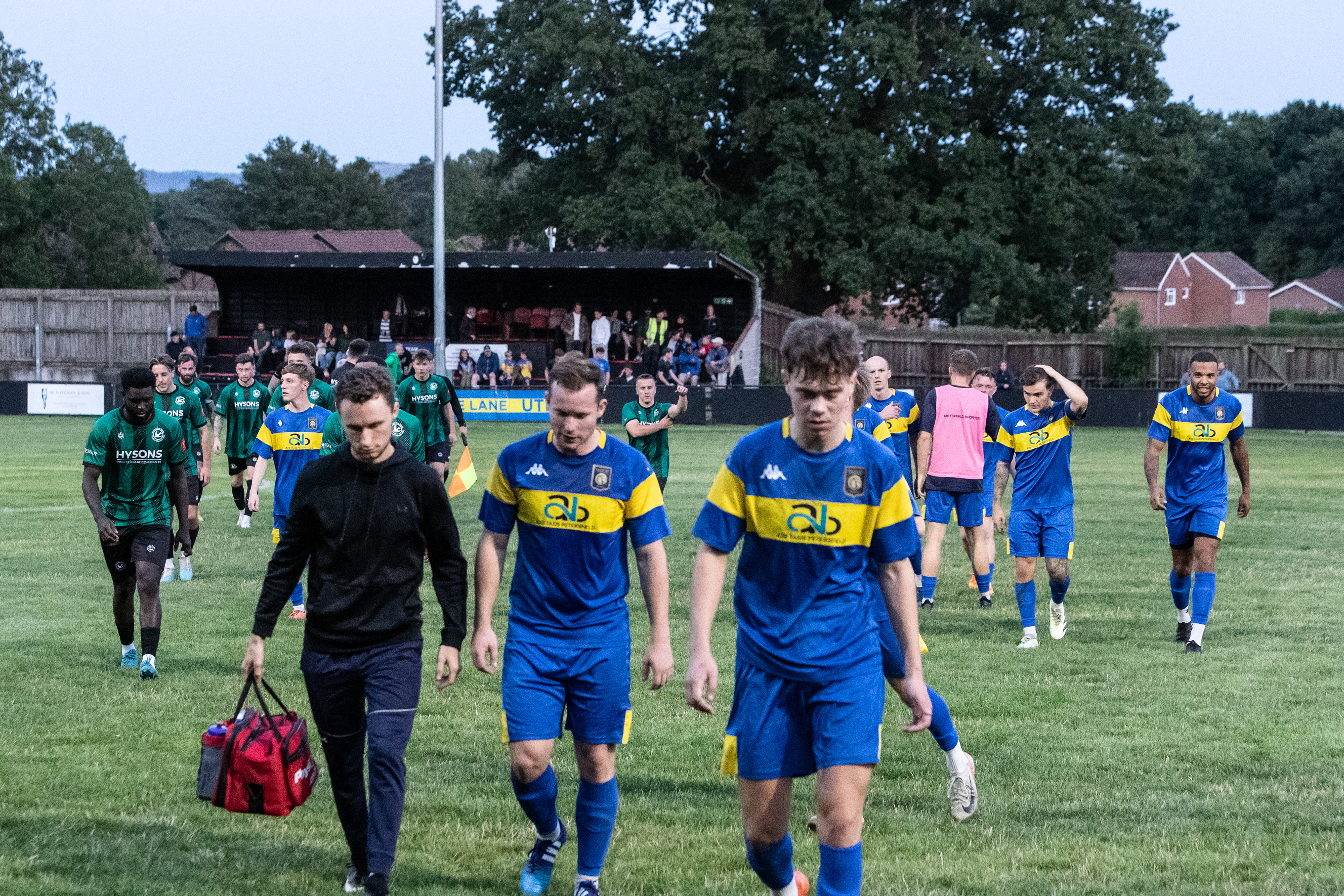 Players leave the pitch at Love Lane