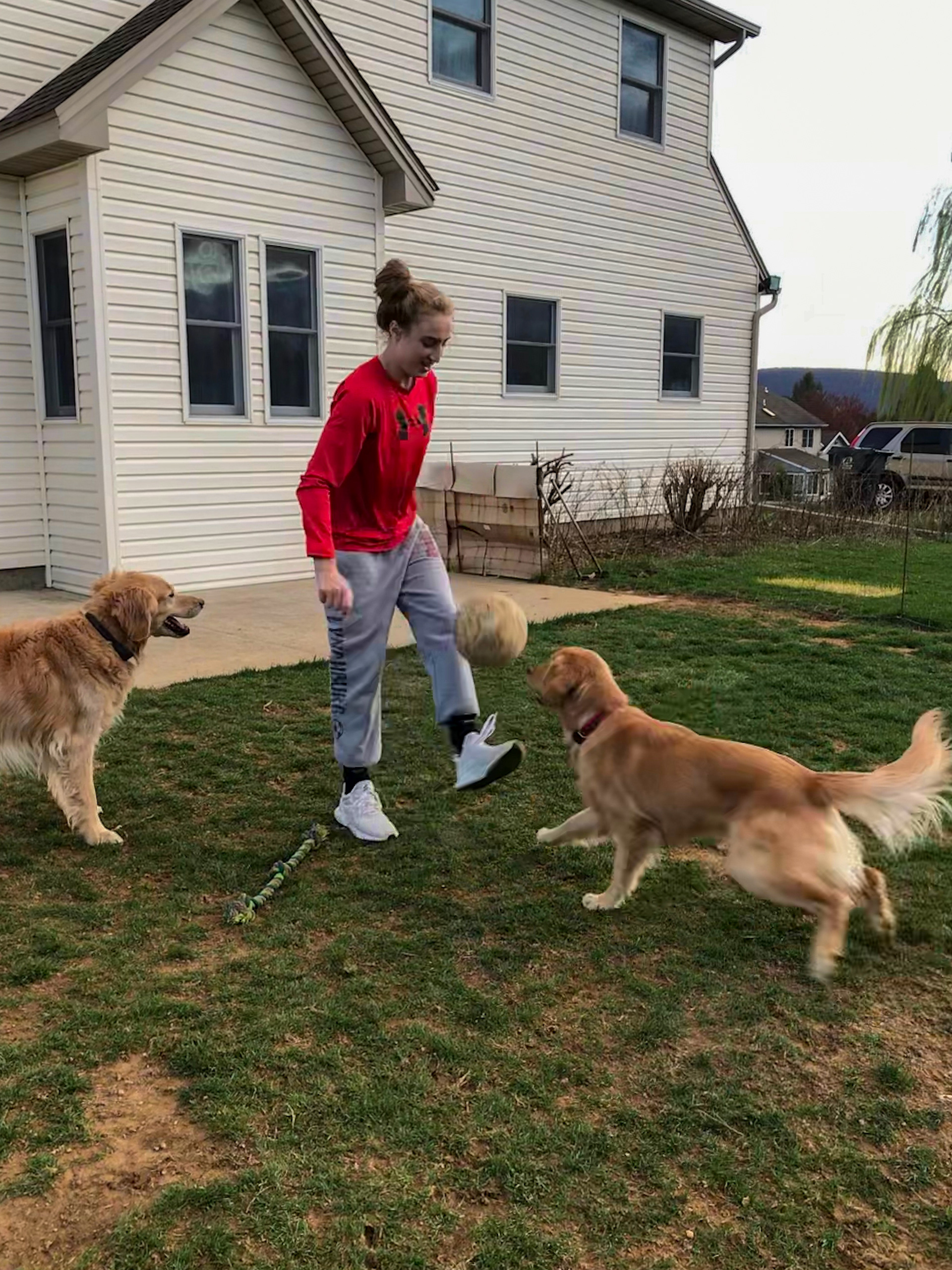 Sarah Pavlovich juggling a soccer ball in her backyard with her dogs, March 30th, 2020. Sarah Pavlovich | Carlisle, Pennsylvania.