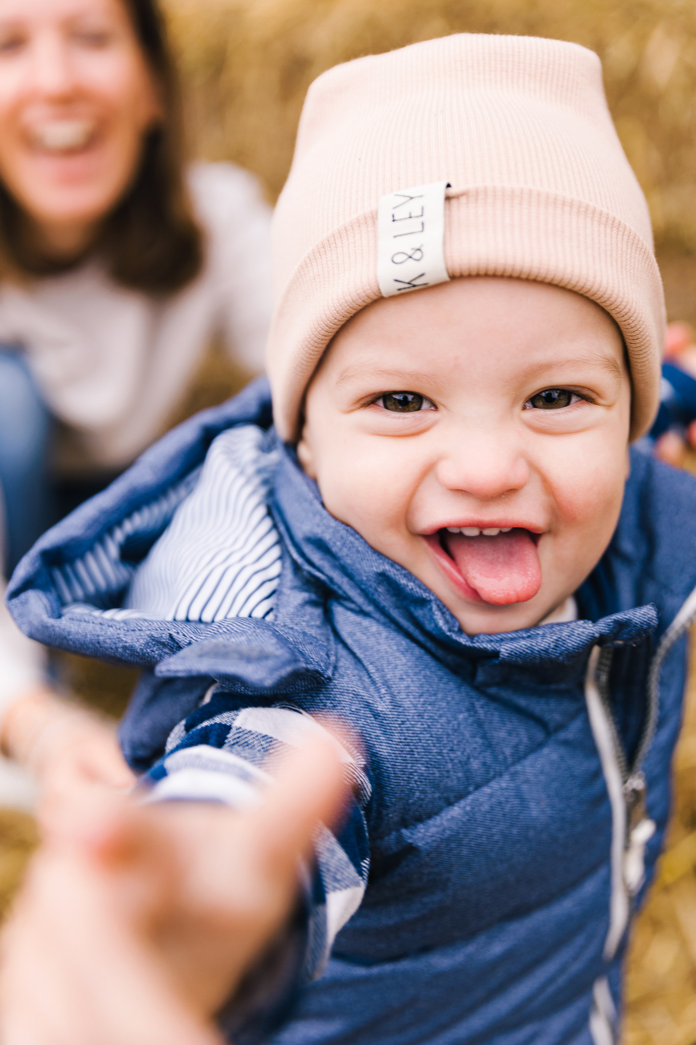 Nahaufnahme eines lachenden Babys auf einem Kürbishof, ideal für Familienfotografie