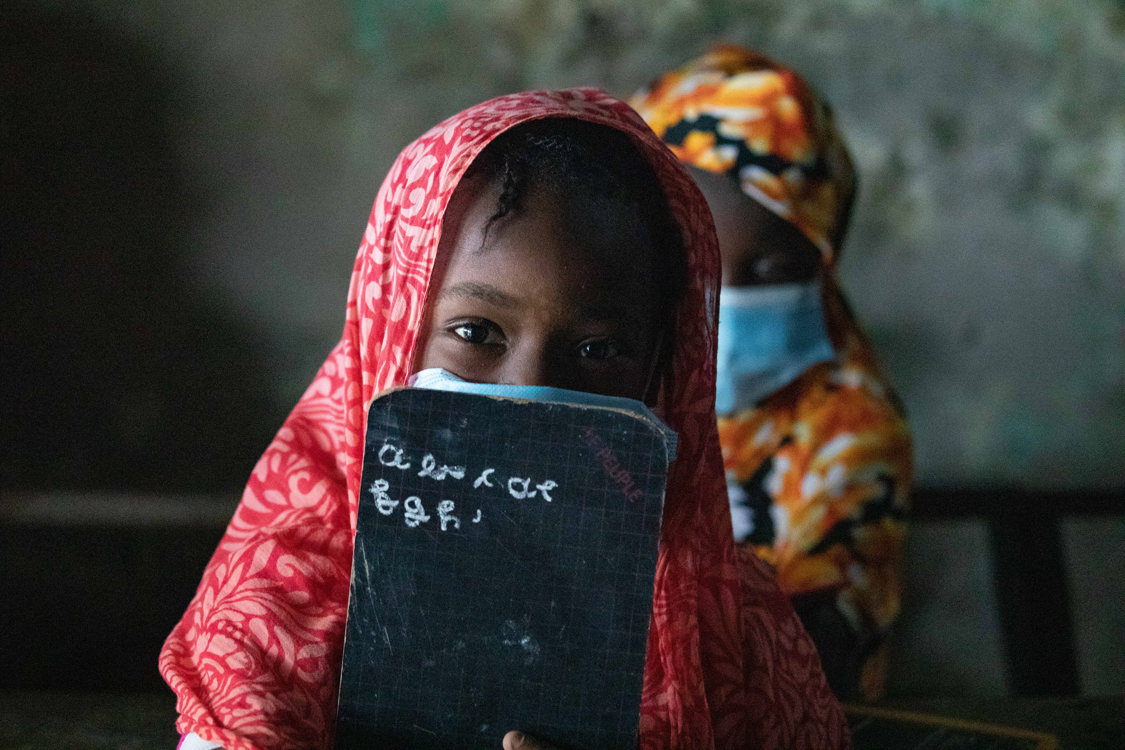 A girl attending classes at an Islamic school in Abobo, Abidjan, on June 29, 2020, wearing a mask during the COVID-19 pandemic, captured by Miléquêm Diarassouba, Photojournalist West Africa.