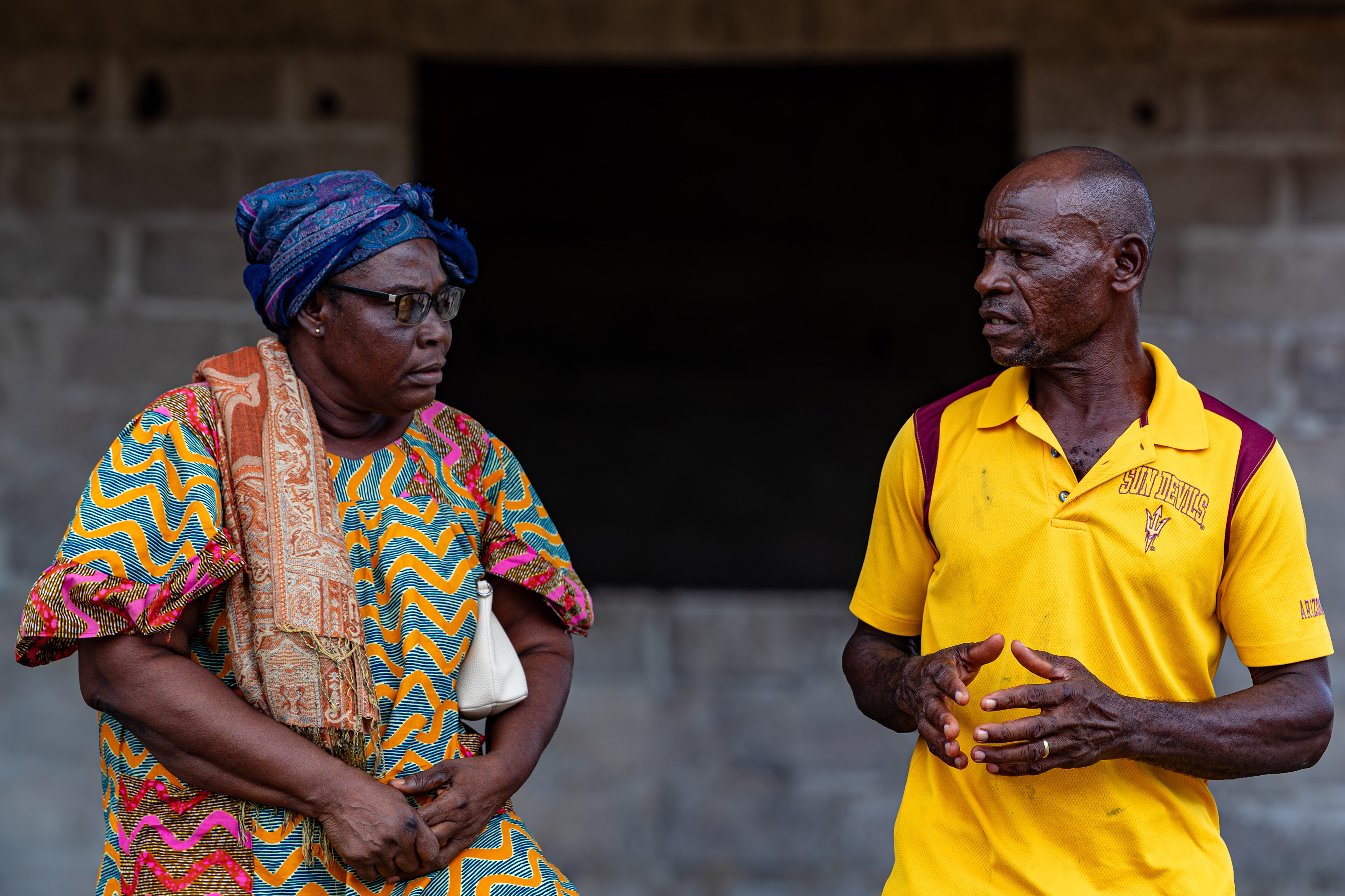 Digbeu Zeze Sylvain, a DREAMS Godfather, talks to Digbeu Cecile, a friend and DREAMS Godmother, in Zokoguhé, a village 18 km from Daloa in western Côte d'Ivoire, on 29 June 2024.