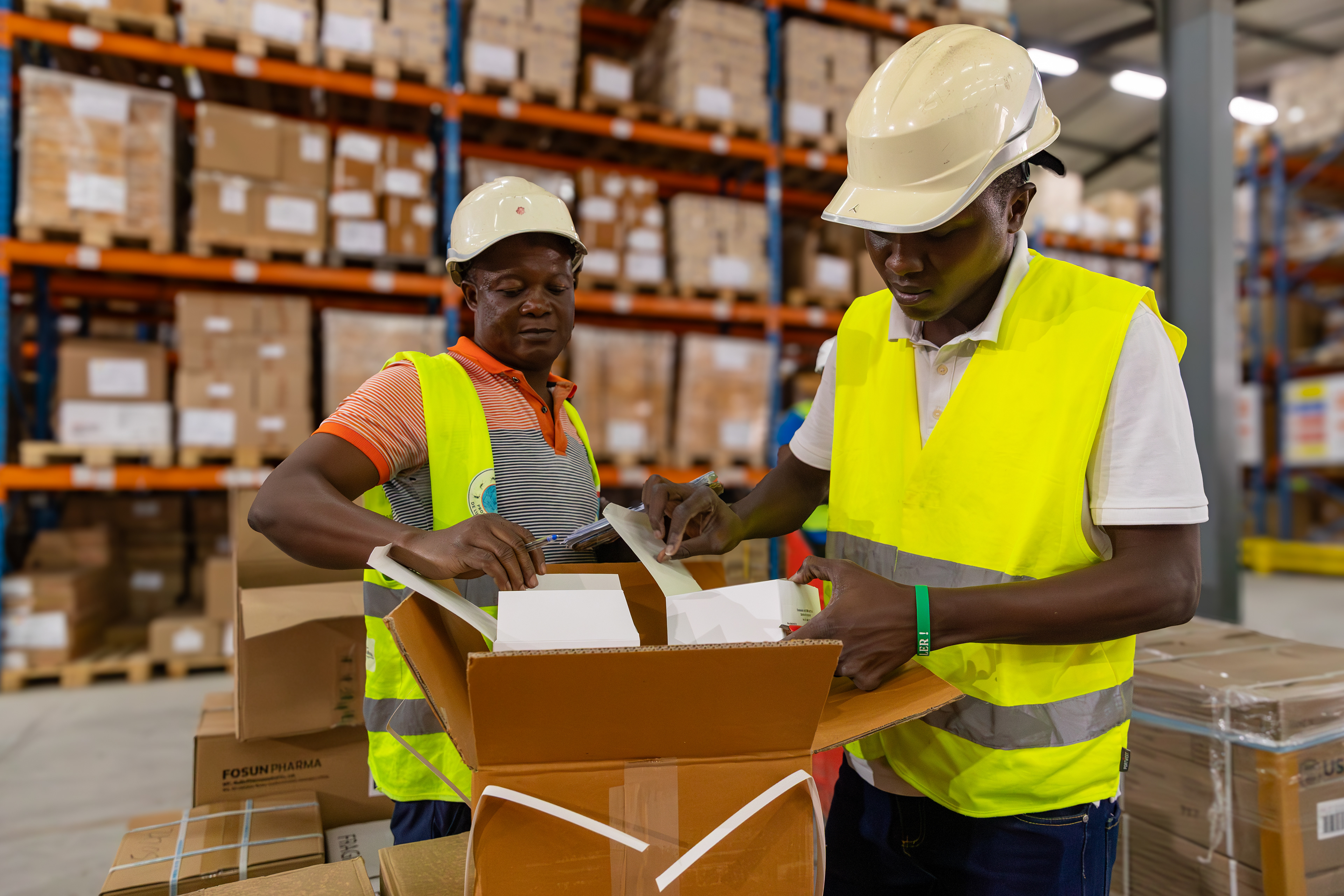 On 8 September 2025 in Abidjan, Ouattara Soualio, responsible for stock monitoring, and Diakité, a check collector, verify medicines at the central warehouse of the Nouvelle Pharmacie de la Santé Publique (NPSP). Their work ensures the accuracy of inventory and the quality control of essential health commodities before distribution to health facilities across Côte d’Ivoire.