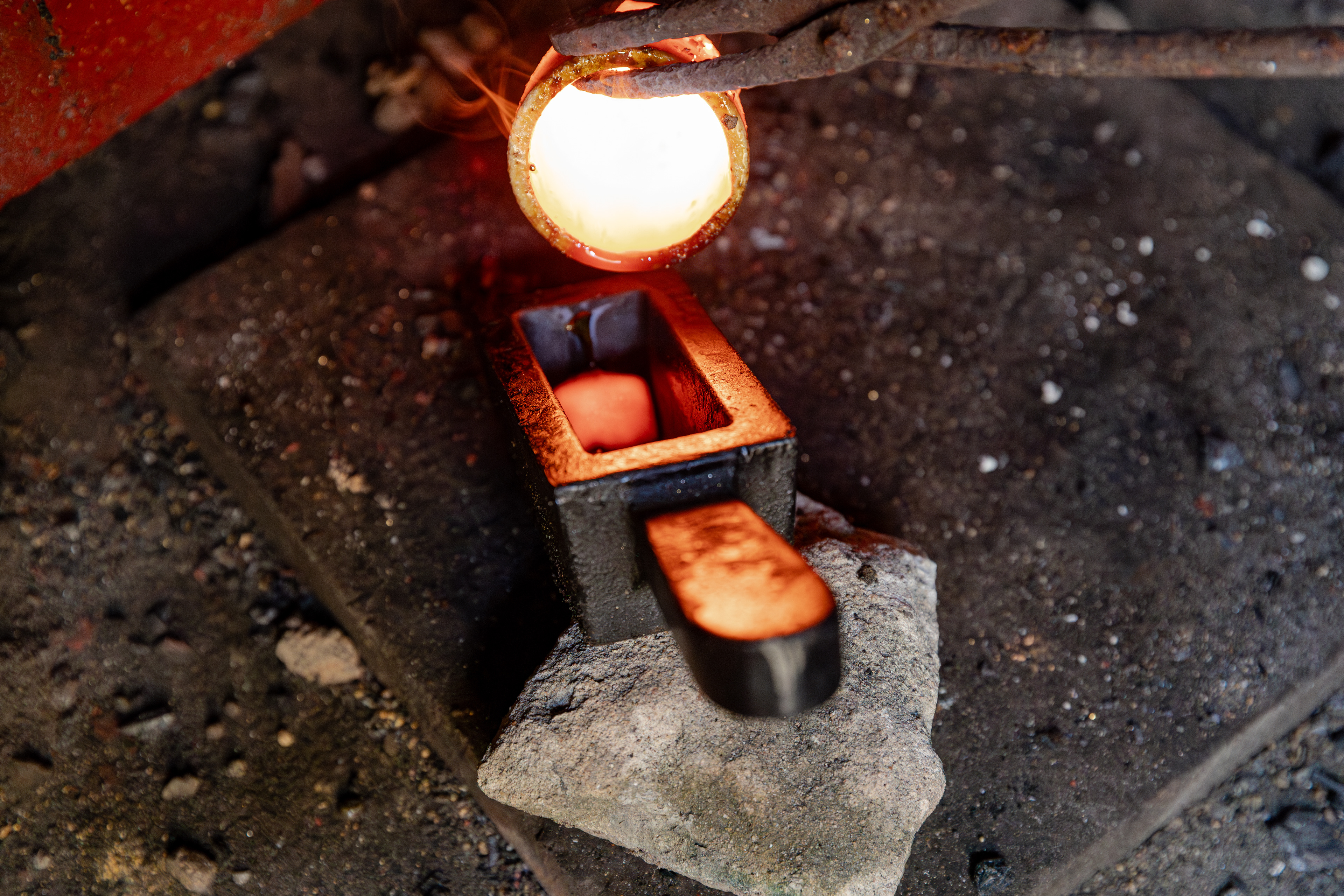Molten gold is poured into a mold during the final stage of the refining process in Dabakala, Côte d’Ivoire.