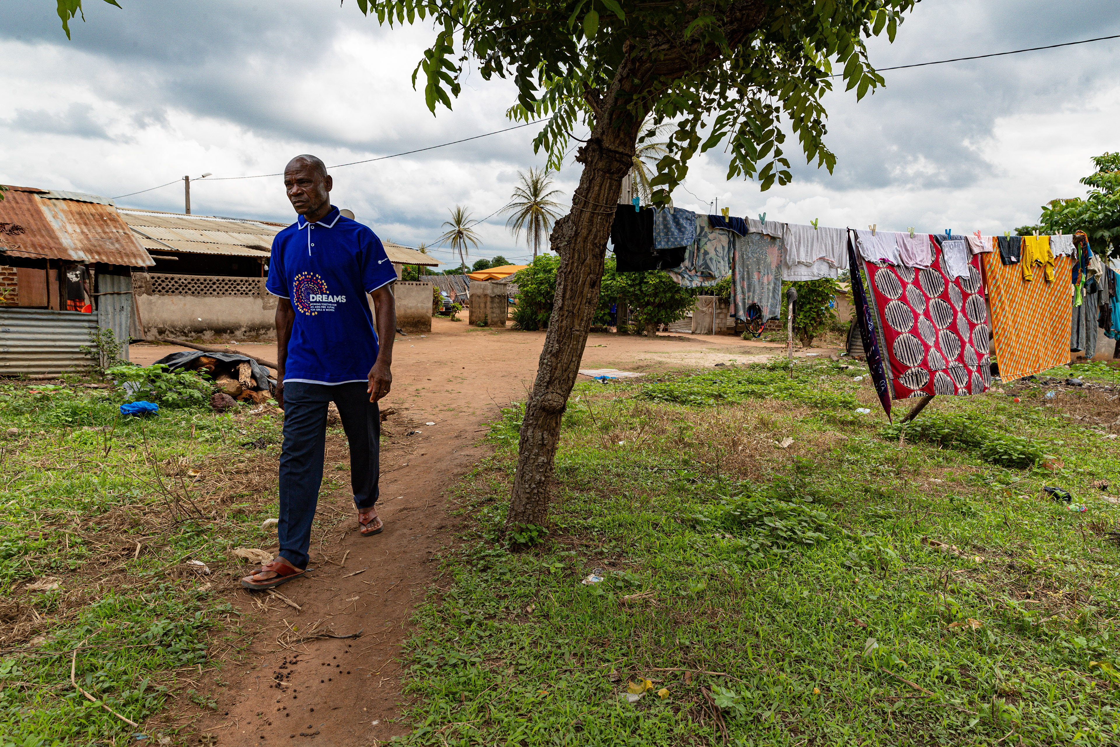 Digbeu Zeze Sylvain, a DREAMS Godfather, walks towards a woman who called on him to resolve a conflict in her village of Zokoguhé, 18 km from Daloa in western Côte d'Ivoire, on 29 June 2024.