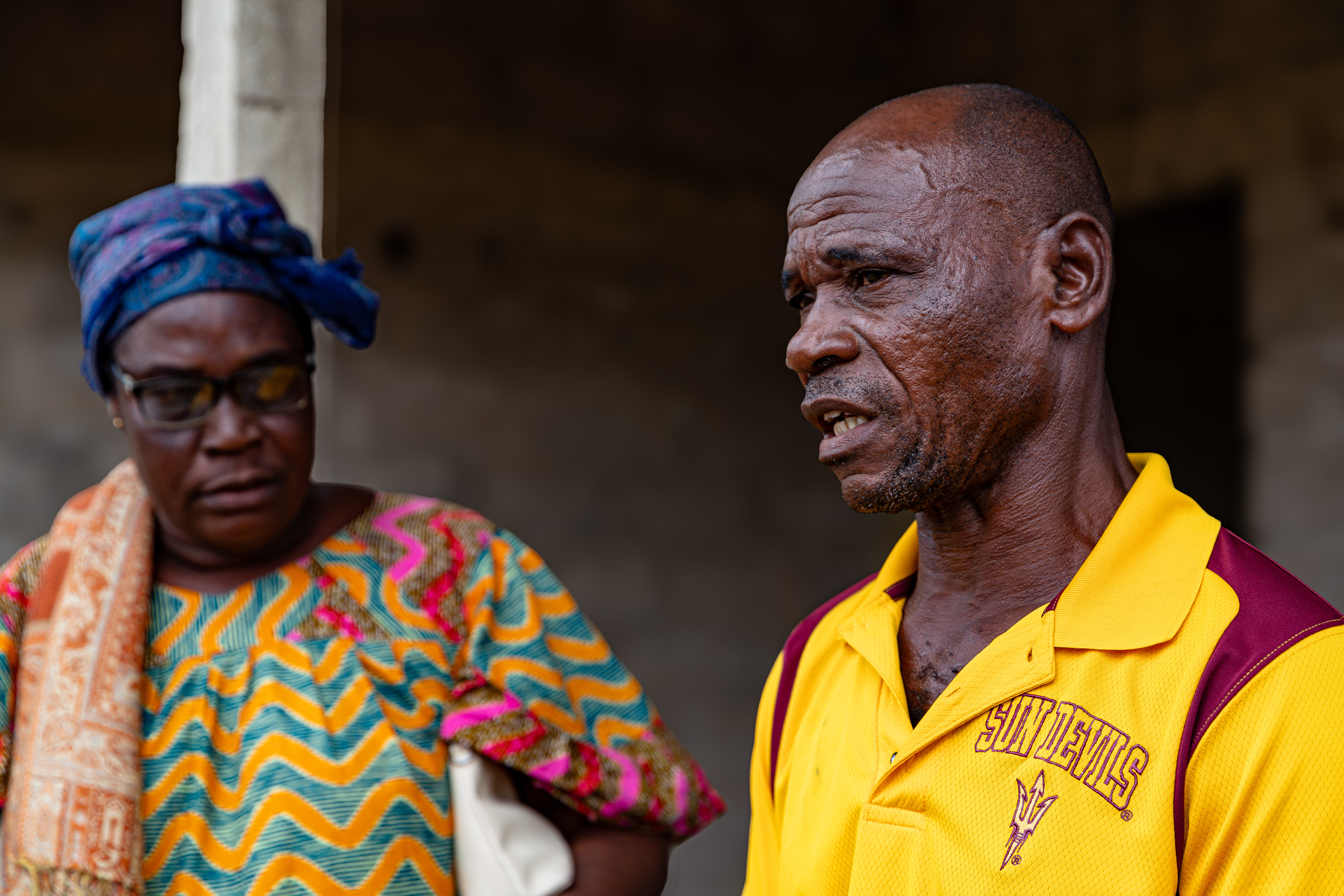 Digbeu Zeze Sylvain, a DREAMS Godfather, talks to Digbeu Cecile, a friend and DREAMS Godmother, in Zokoguhé, a village 18 km from Daloa in western Côte d'Ivoire, on 29 June 2024.